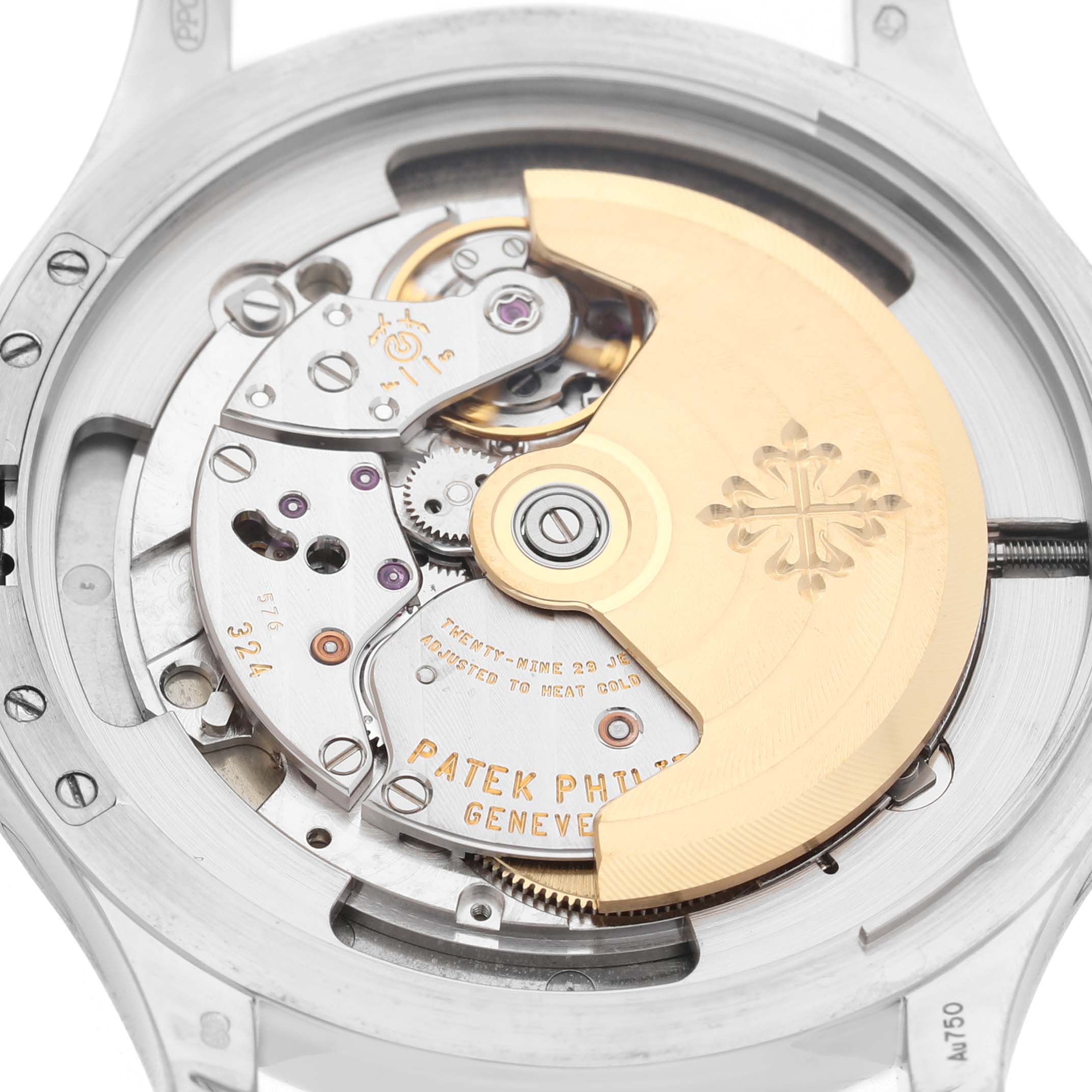 The image shows a close-up view of the movement of a Patek Philippe Calatrava 5227G-001 Men's White Gold Beige Dial watch, featuring the rotor and mechanical components.