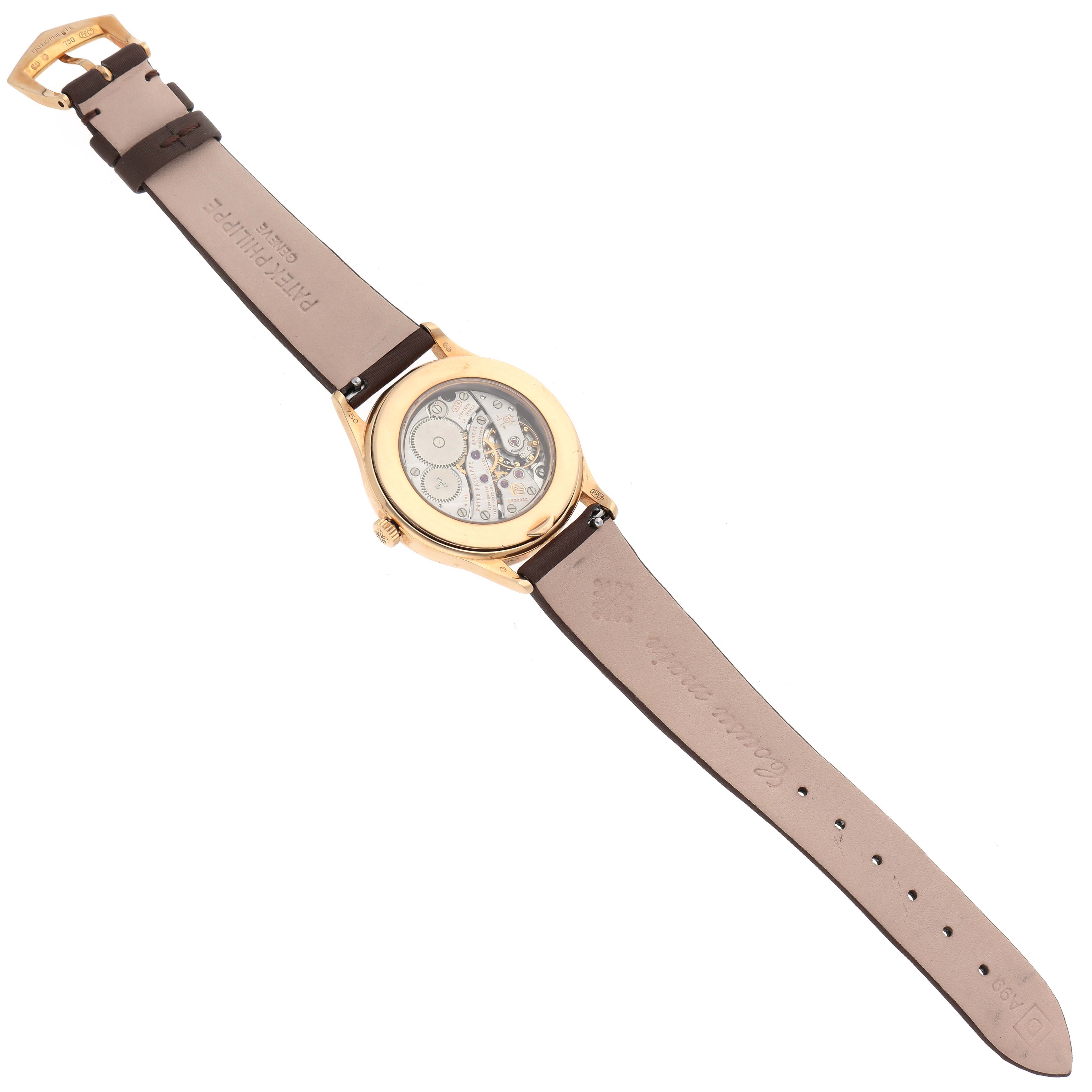 This image shows the back view of a Patek Philippe Calatrava 4897R-001 Women's Rose Gold Brown Dial 4897R-001 Women's Rose Gold Brown Dial watch, displaying its mechanical movement and leather strap.