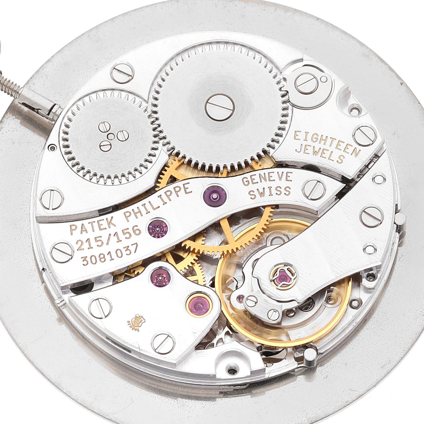 The image shows the intricate inner mechanism of a Patek Philippe Calatrava 5034G Men
s White Gold White Dial 5034G Men
s White Gold White Dial watch, highlighting gears, jewels, and engravings.