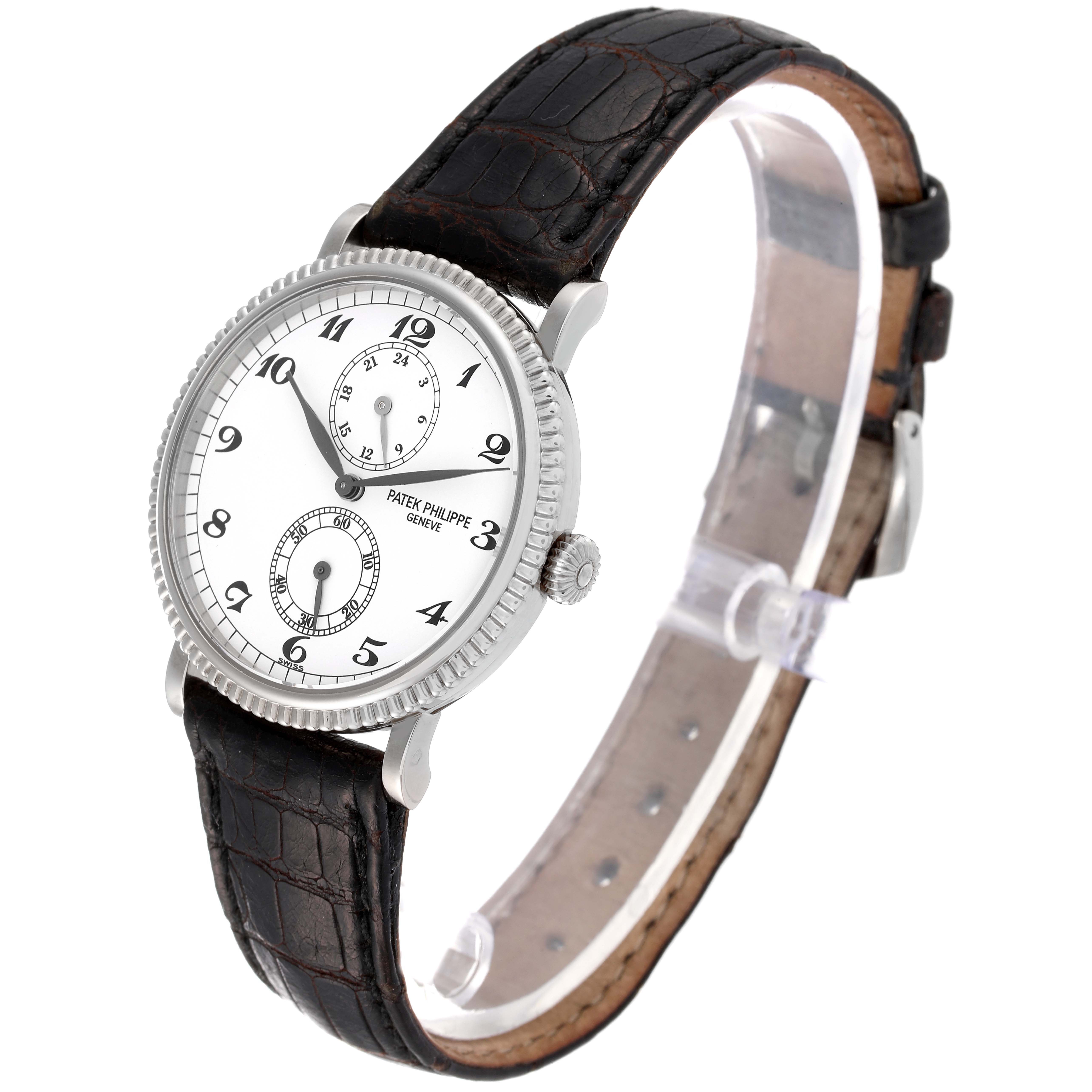 The image shows a Patek Philippe Calatrava 5034G Men
s White Gold White Dial 5034G Men
s White Gold White Dial watch at a three-quarter angle, highlighting its dial, bezel, crown, and leather strap.