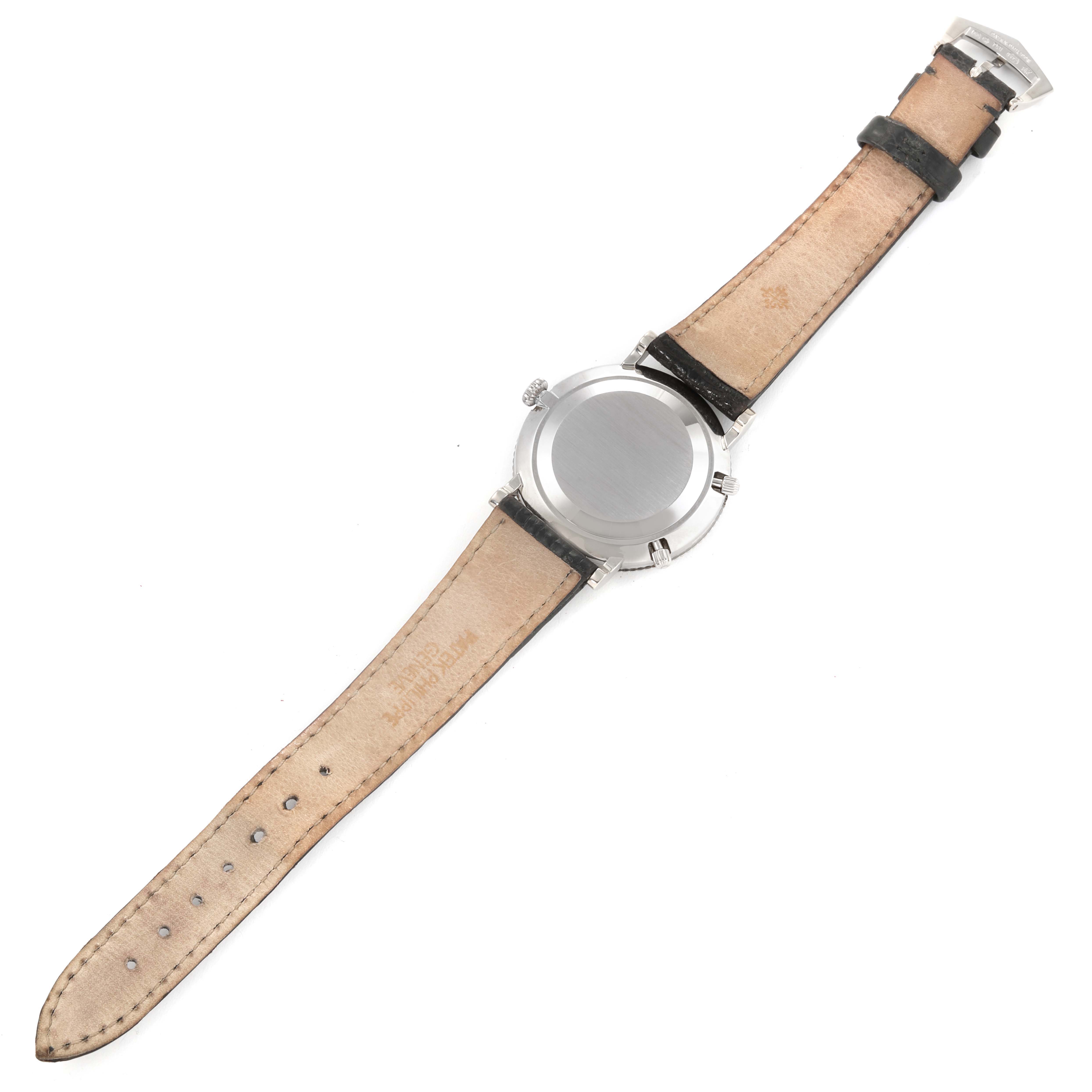 The image shows the back view of a Patek Philippe Calatrava 5034G Men
s White Gold White Dial 5034G Men
s White Gold White Dial watch with its leather strap fully extended.