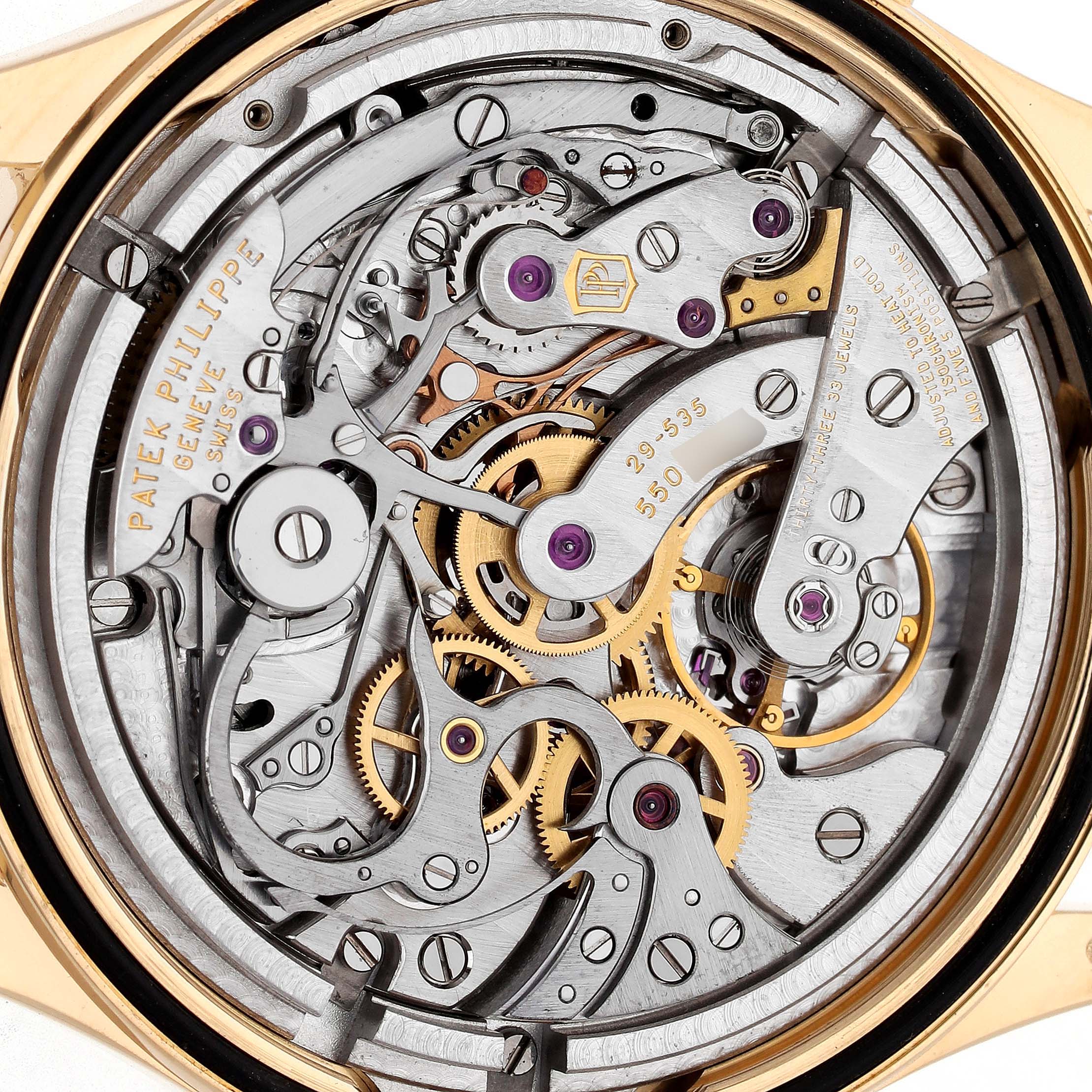 The image shows the intricate movement of a Patek Philippe Complications 5170J-001 Men's Yellow Gold Silver Dial watch from the back, highlighting gears and mechanisms.