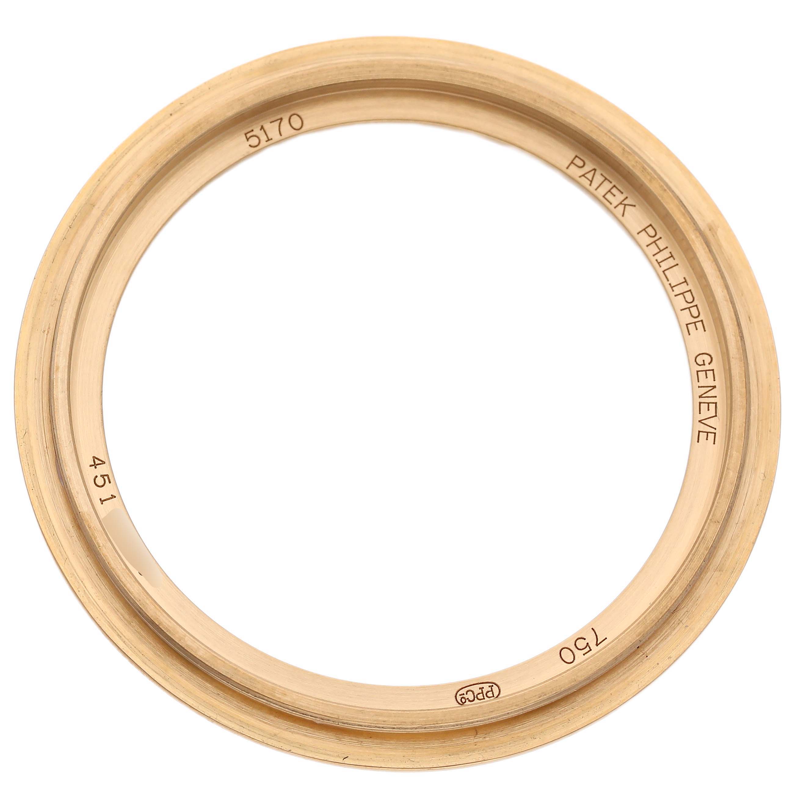The image shows a top-down view of a bezel ring from a Patek Philippe Complications 5170J-001 Men's Yellow Gold Silver Dial model, with engravings visible.