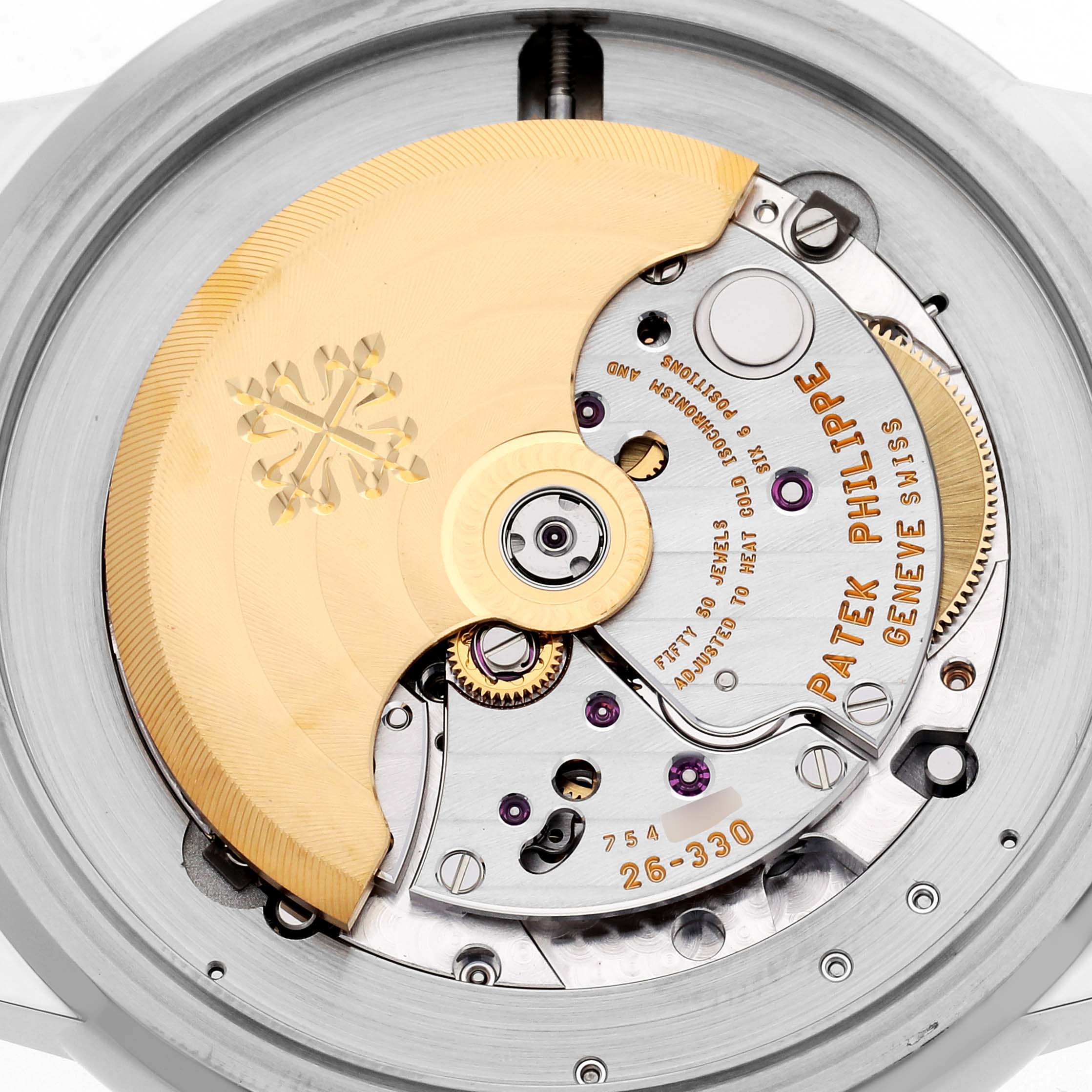 The image shows the movement of a Patek Philippe Complications 5212A-001 Men
s Stainless Steel Silver Dial 5212A-001 Men
s Stainless Steel Silver Dial watch, highlighting gears and inscriptions from a top-down angle.