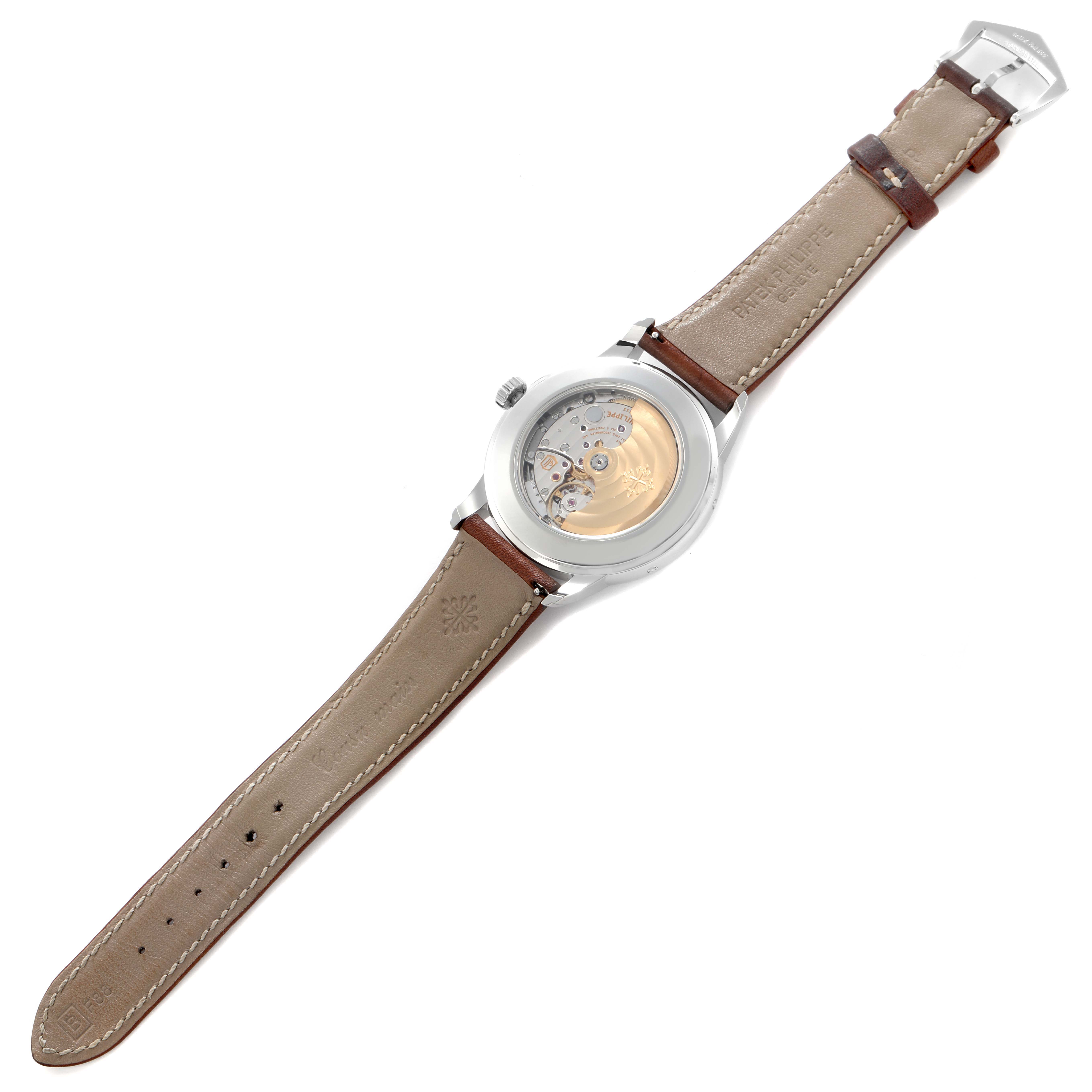 The image shows the back view of the Patek Philippe Complications 5212A-001 Men
s Stainless Steel Silver Dial 5212A-001 Men
s Stainless Steel Silver Dial watch, displaying its movement and leather strap.