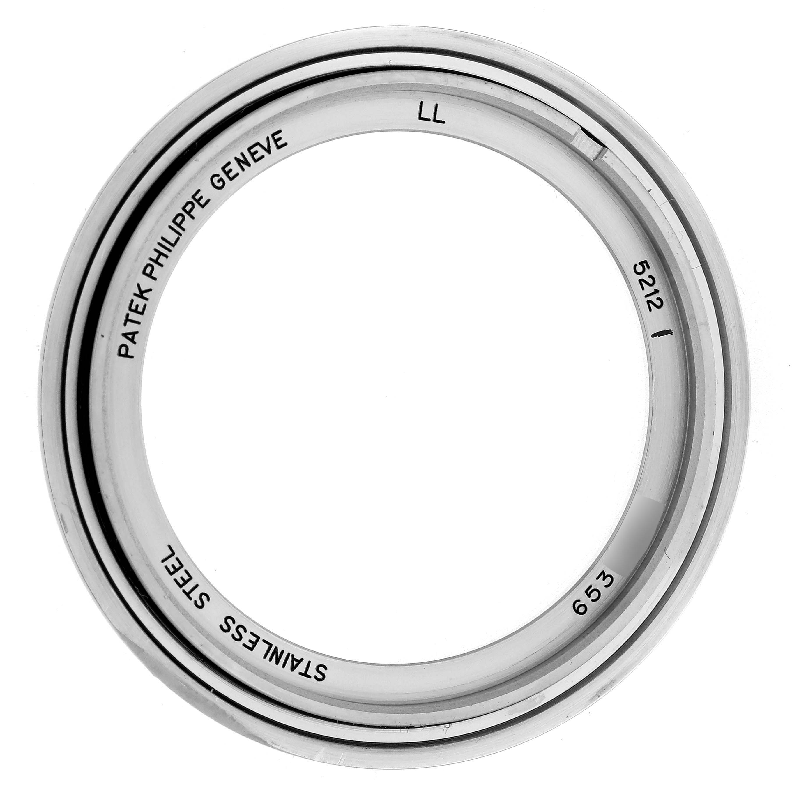 The image shows a top view of a stainless steel bezel for a Patek Philippe Complications 5212A-001 Men
s Stainless Steel Silver Dial 5212A-001 Men
s Stainless Steel Silver Dial model watch, with engravings inside.