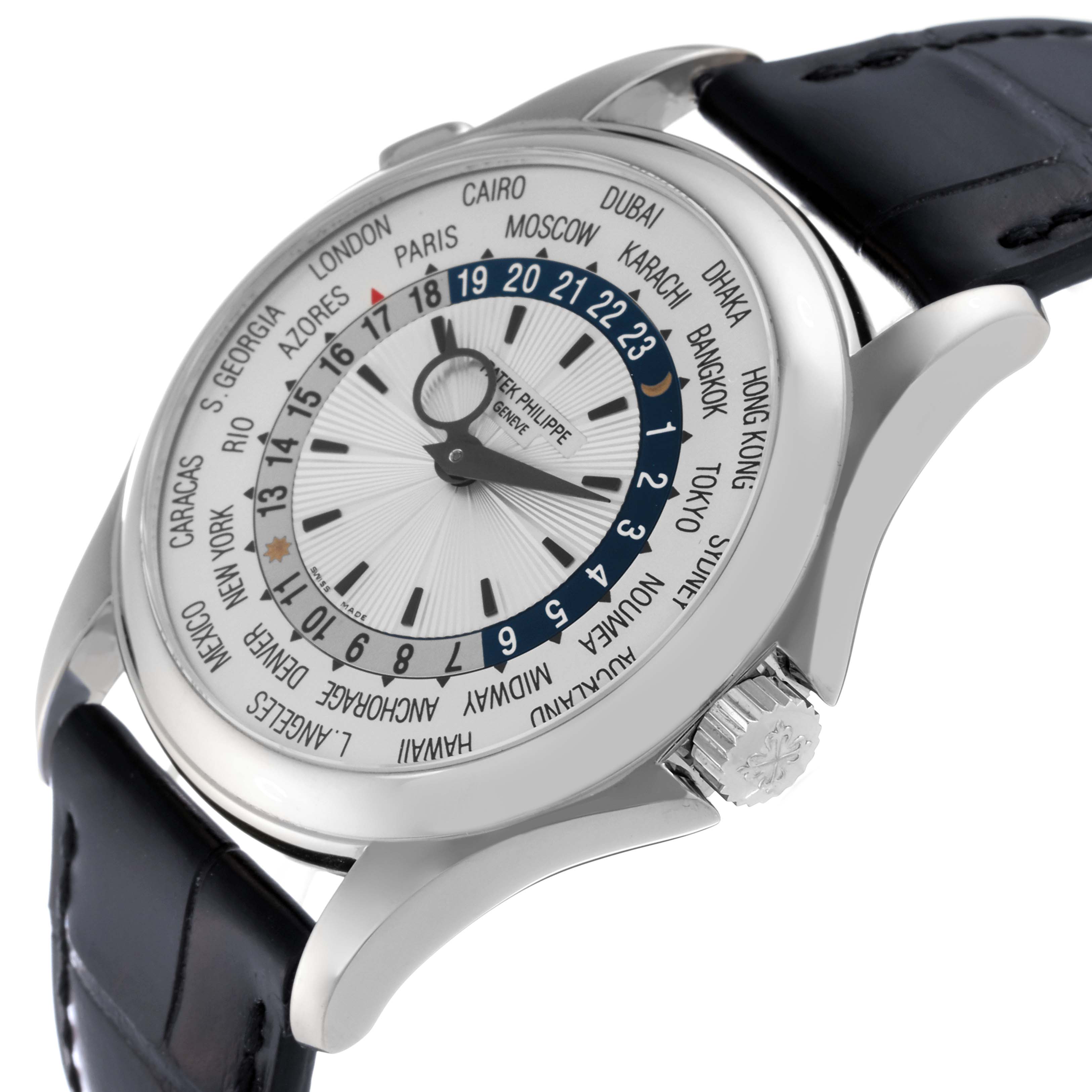 This Patek Philippe Complications 5130G Men
s White Gold Silver Dial 5130G Men
s White Gold Silver Dial model watch is shown from a three-quarter angle, highlighting the crown, bezel, and face detailing world time zones.