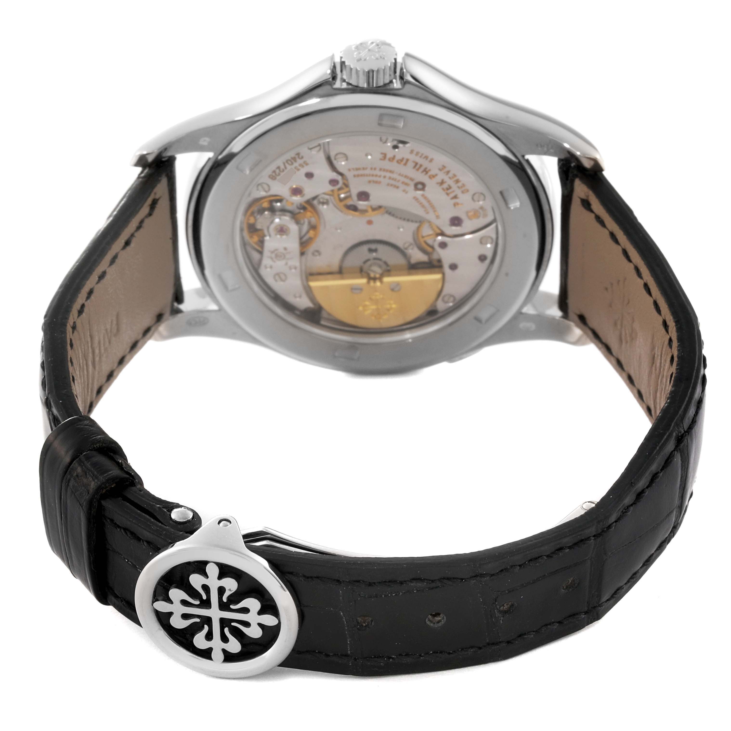 The image shows the back view of the Patek Philippe Complications 5130G Men
s White Gold Silver Dial 5130G Men
s White Gold Silver Dial watch, highlighting its internal mechanism and leather strap.