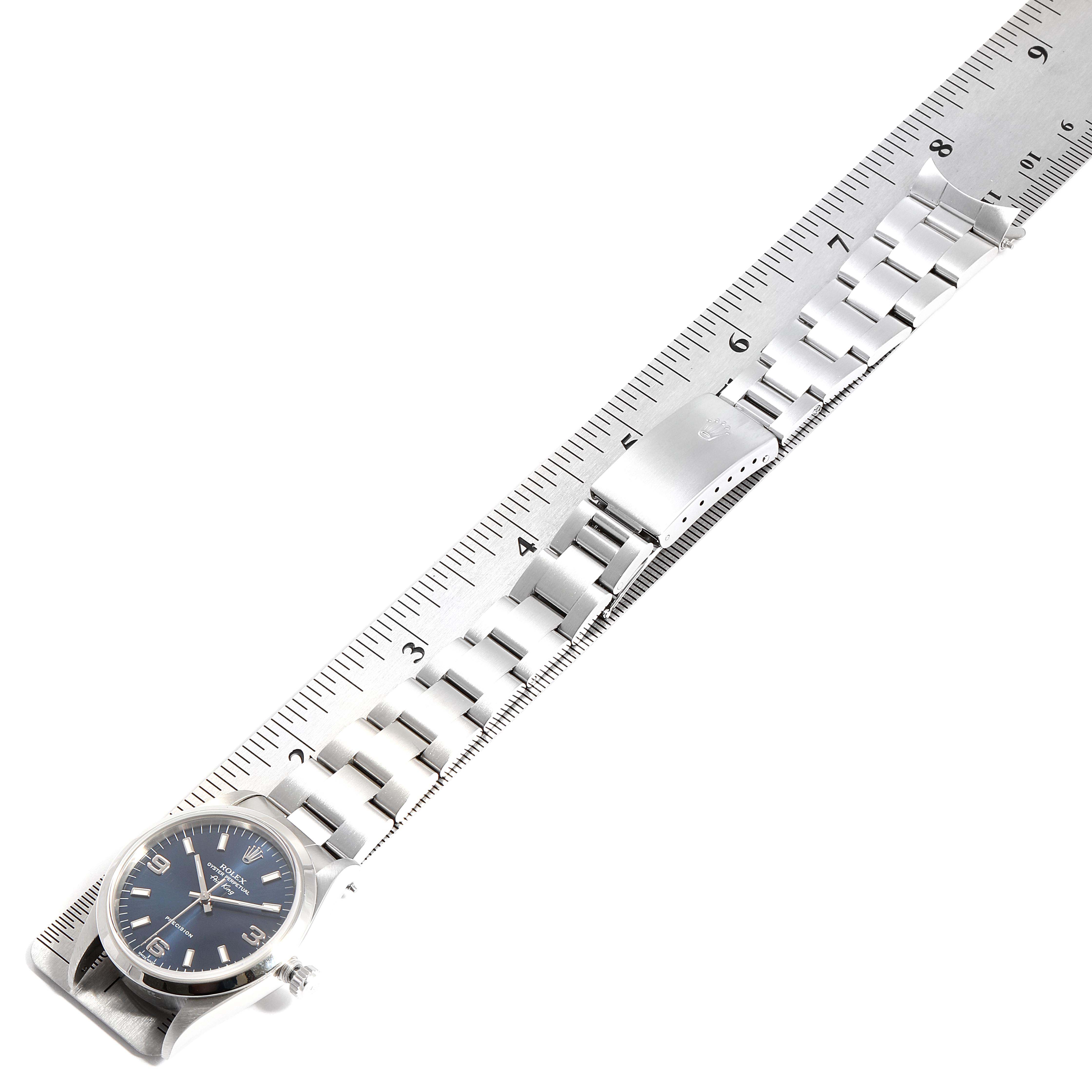 The image shows a Rolex Air-King 14000 Men's Stainless Steel Blue Dial 14000 Men's Stainless Steel Blue Dial watch laid flat against a ruler, displaying its full stainless steel bracelet and clasp.