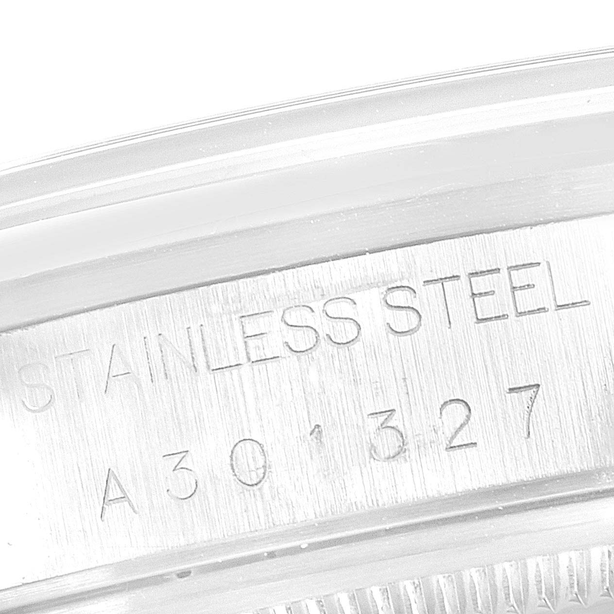 This close-up image shows the serial number and "STAINLESS STEEL" engraving on the casing of a Rolex Air-King 14000 Men's Stainless Steel Blue Dial 14000 Men's Stainless Steel Blue Dial watch.