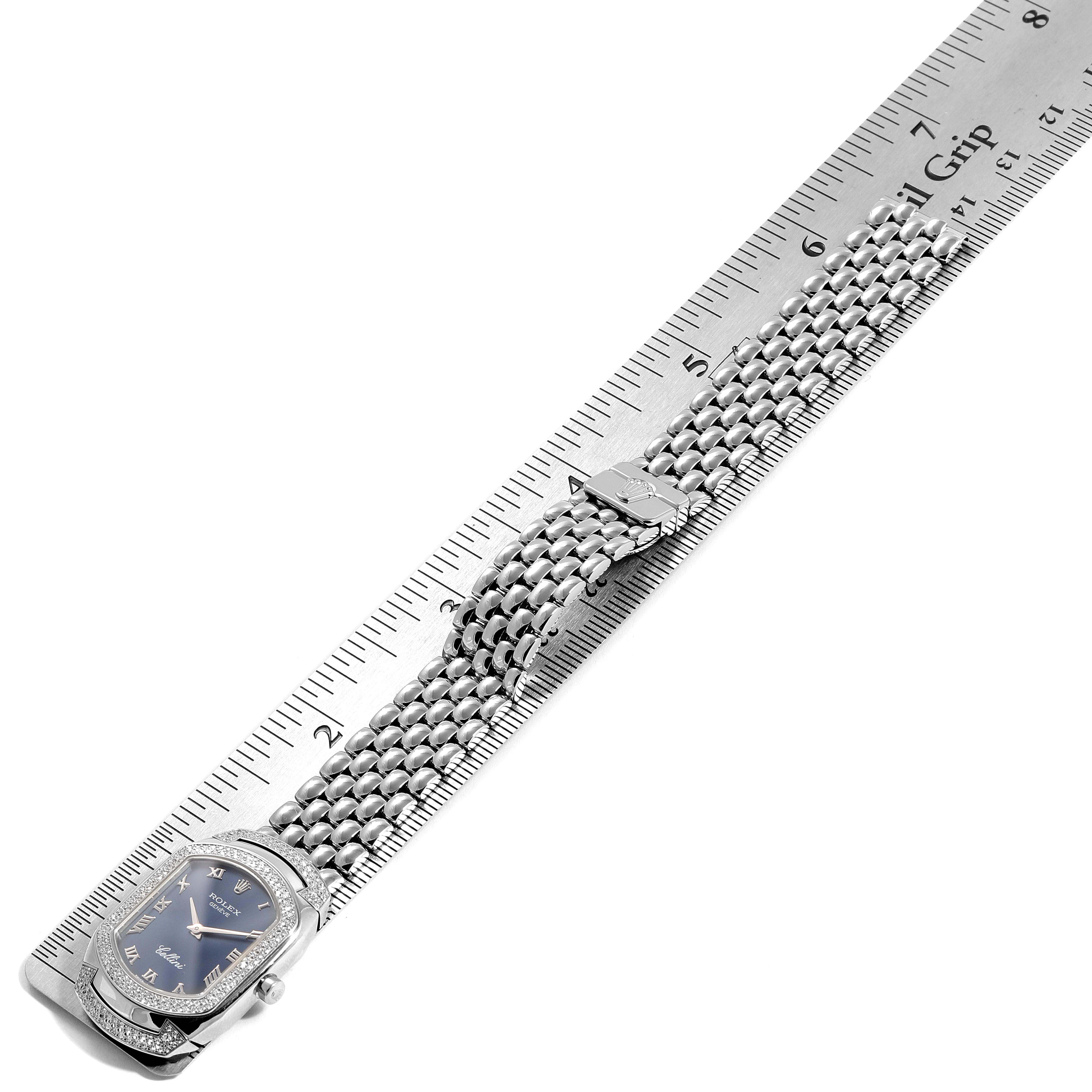 The image shows the Rolex Cellini 6693 Women's White Gold Blue Dial 6693 Women's White Gold Blue Dial watch from a top-down angle, highlighting its face, bezel, and metal bracelet next to a ruler for scale.