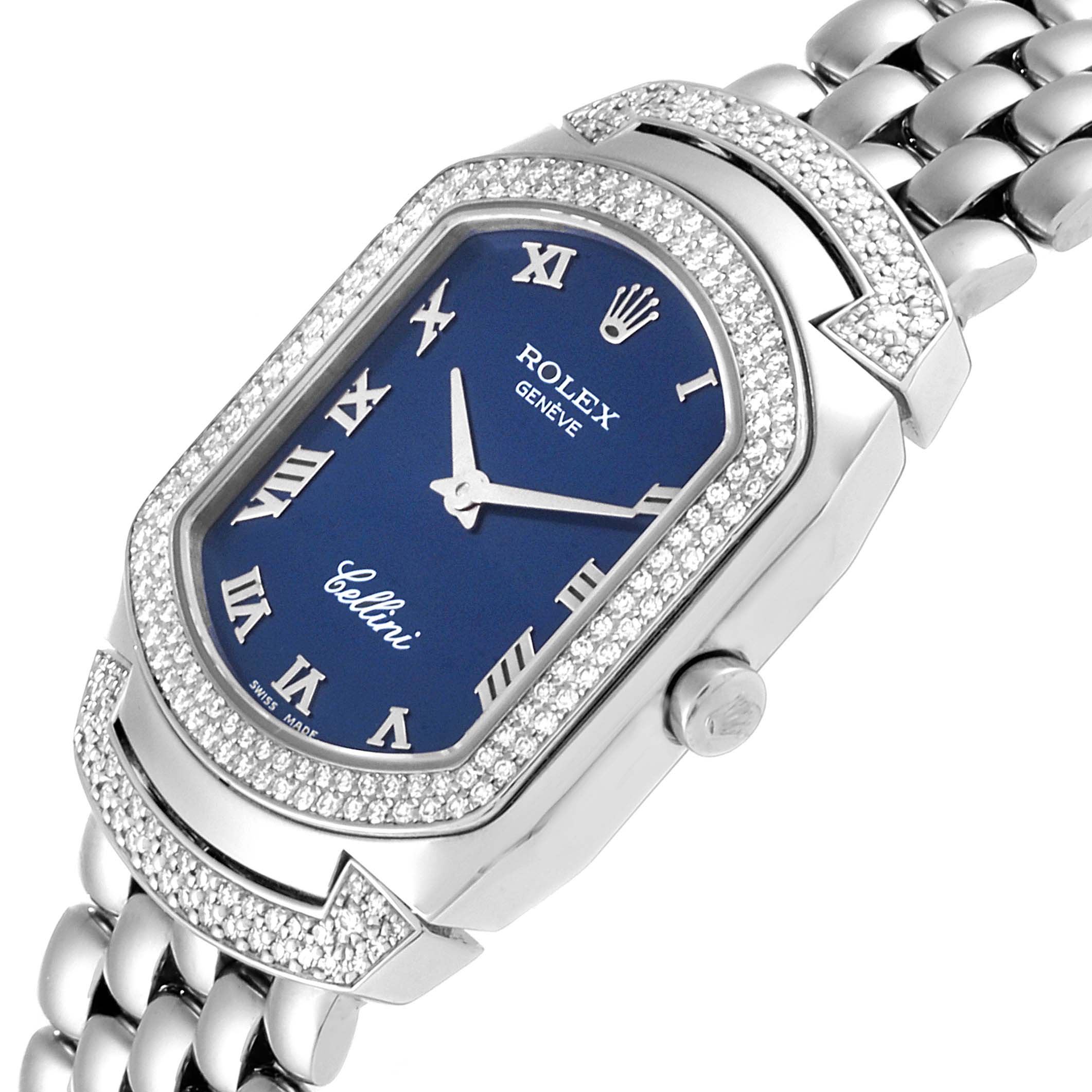 This Rolex Cellini 6693 Women's White Gold Blue Dial 6693 Women's White Gold Blue Dial watch is shown from an angled close-up, emphasizing the blue dial, silver Roman numerals, diamond bezel, and metal bracelet.