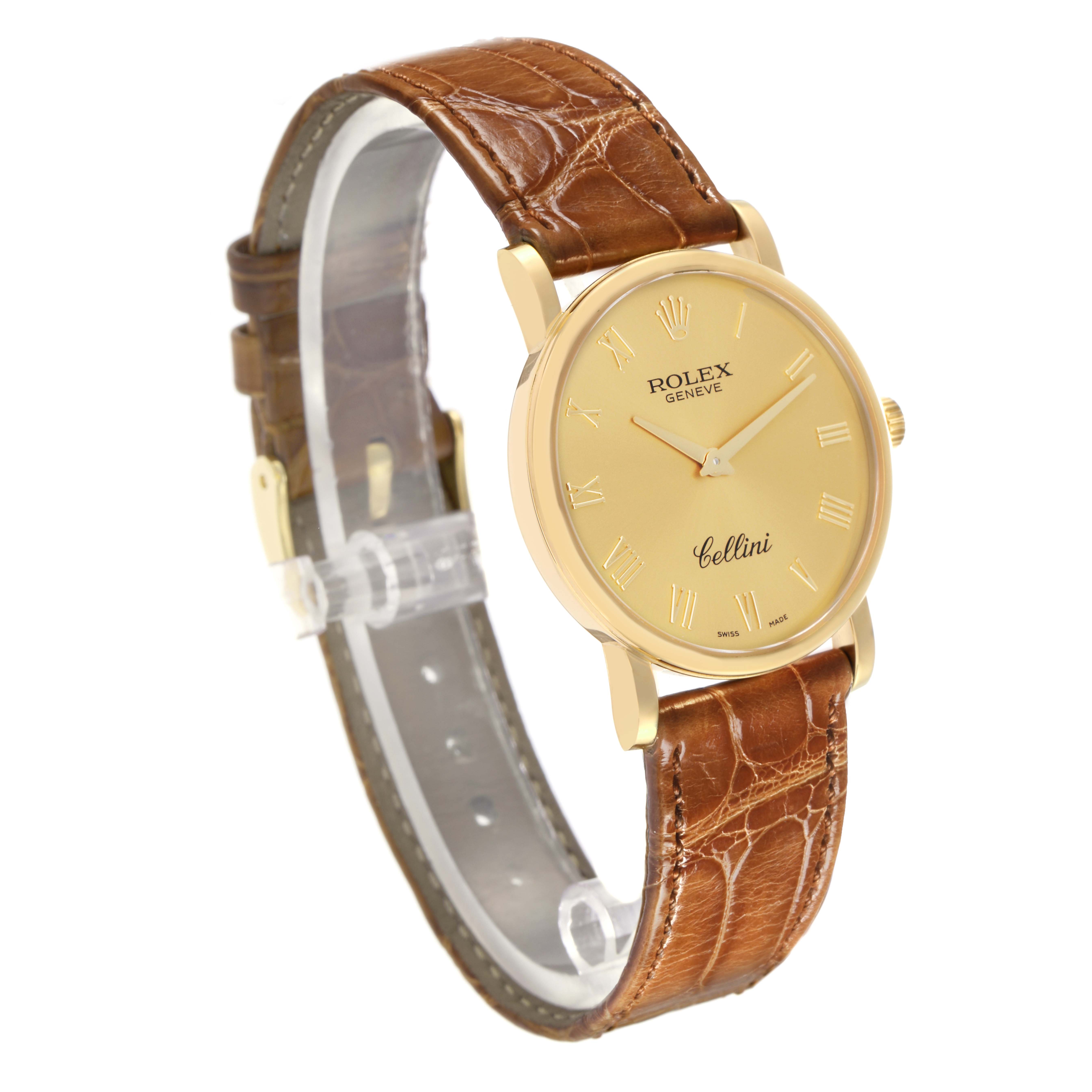 The Rolex Cellini 5115 Men's Yellow Gold Champagne Dial 5115 Men's Yellow Gold Champagne Dial watch is shown at a three-quarter angle, displaying its gold case, dial with Roman numerals, and brown leather strap.