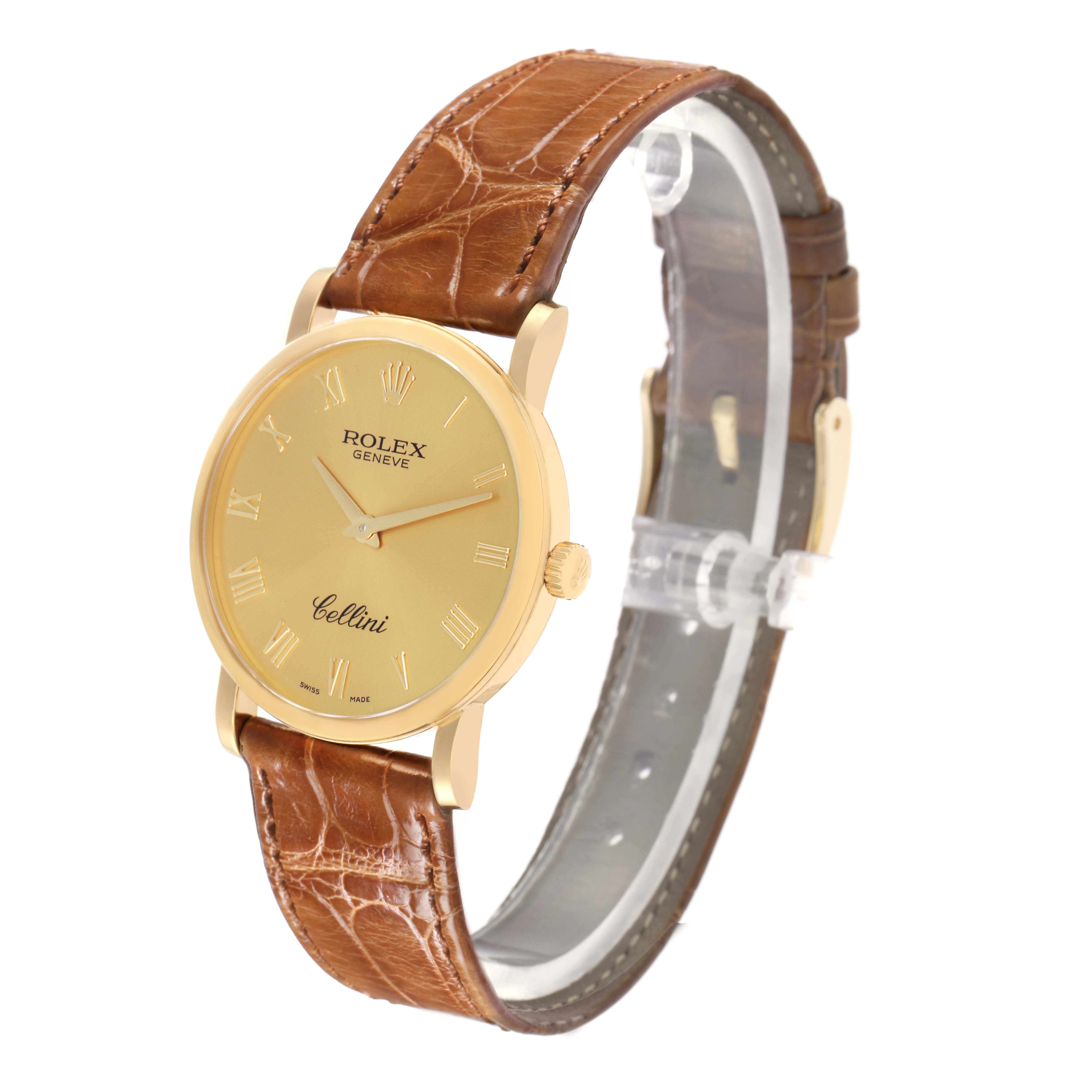 The Rolex Cellini 5115 Men's Yellow Gold Champagne Dial 5115 Men's Yellow Gold Champagne Dial watch is shown at a three-quarter angle, highlighting its gold dial, leather strap, and side crown.