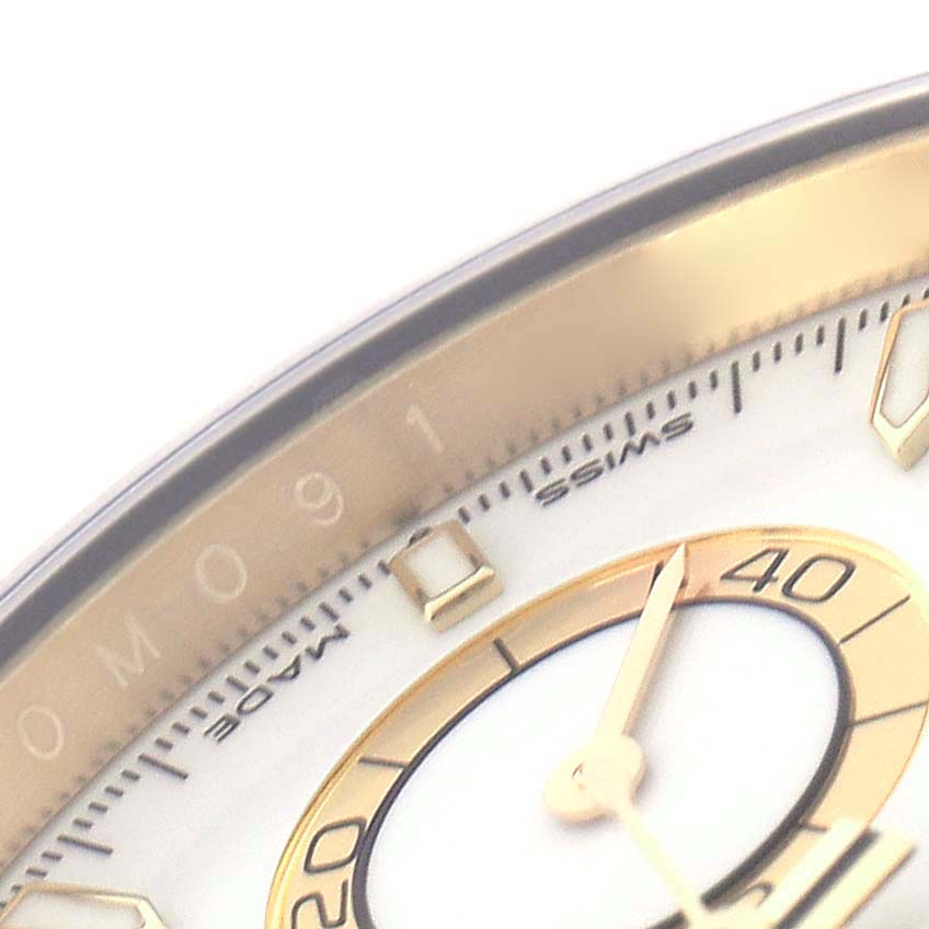 The image shows a close-up of a Rolex Daytona 126518 Men
s Yellow Gold White Dial 126518 Men
s Yellow Gold White Dial watch face, highlighting the bezel, hour markers, and a portion of the dial.
