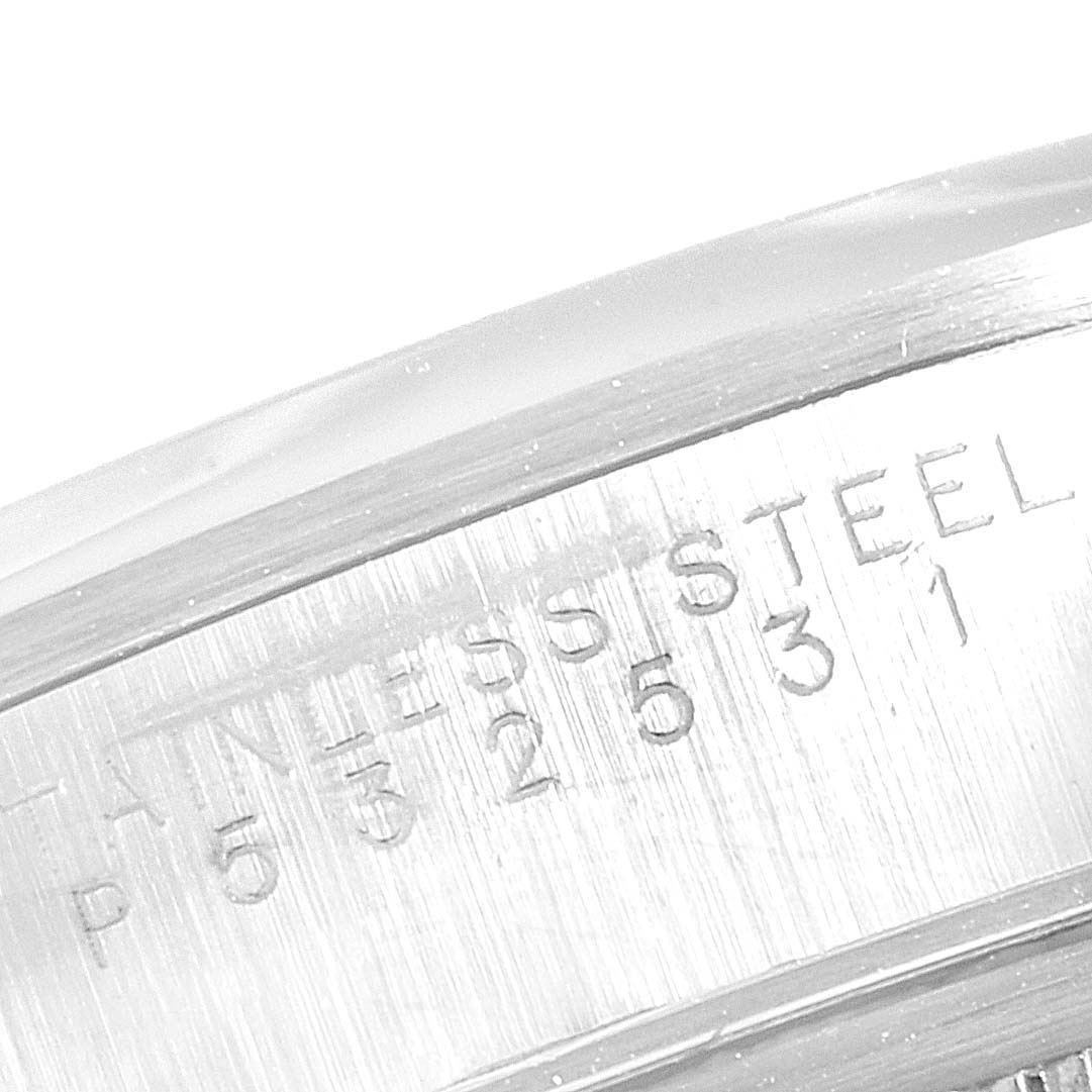This close-up image shows the engraved text on the case of a Rolex Date 15200 Men's Stainless Steel Black Dial 15200 Men's Stainless Steel Black Dial model, including the serial number and material.
