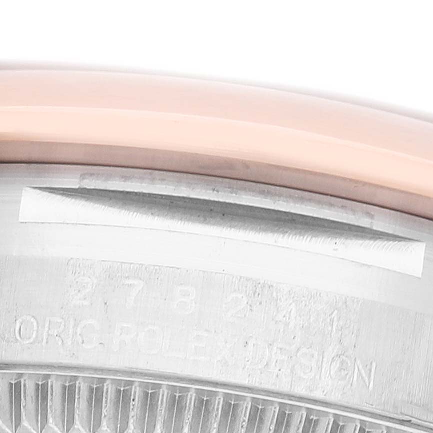 The image shows a close-up of the side of a Rolex Datejust 278241-0009 Women's Steel and Gold (two tone) Pink Dial, highlighting the bezel edge and engraved serial details.