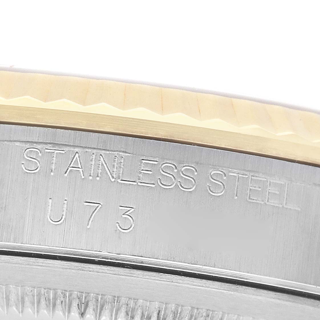 The image shows a close-up of the stainless steel case side with engraving, and part of the bezel of a Rolex Datejust 16233 Men's Steel and Gold (two tone) Champagne Dial watch.