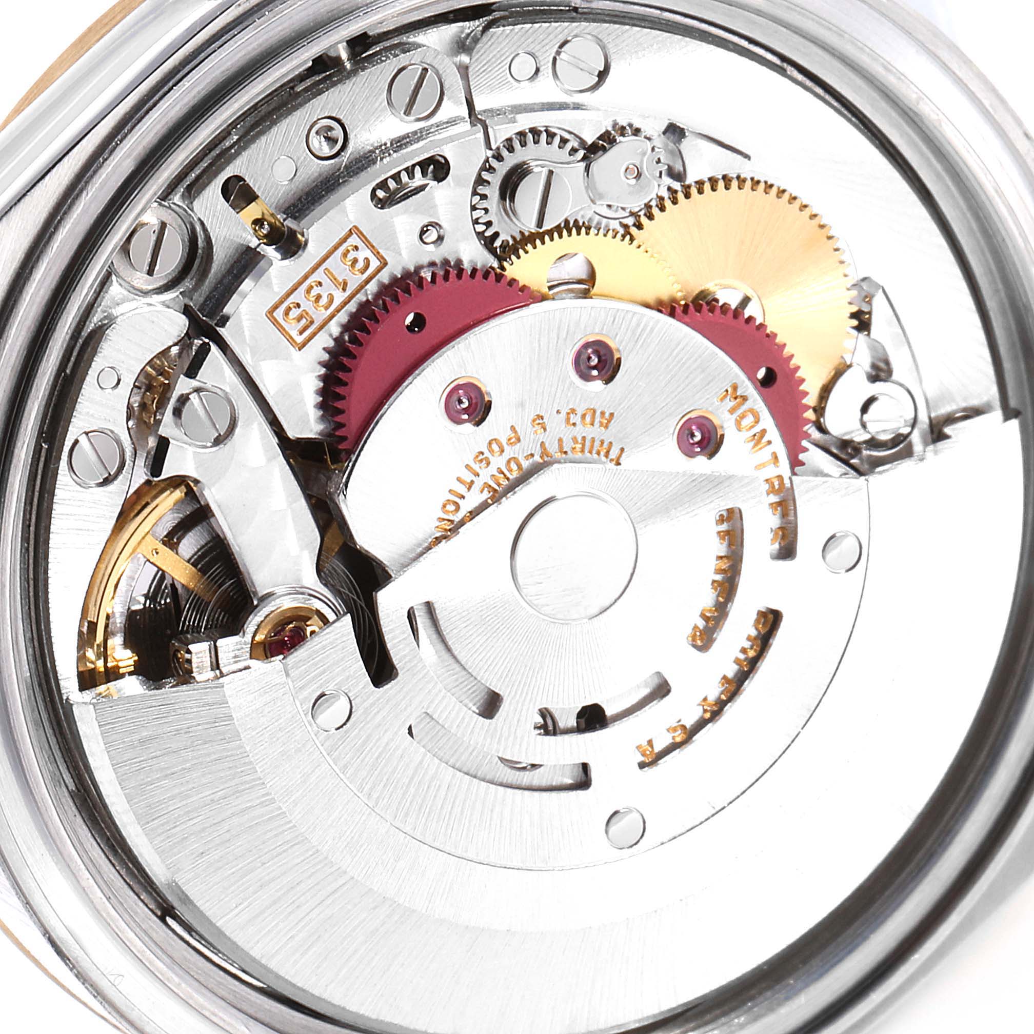The image shows the intricate movement and inner workings of a Rolex Datejust 16203 Men
s Steel and Gold (two tone) Grey Dial 16203 Men
s Steel and Gold (two tone) Grey Dial watch, focusing on its gears and mechanical parts.