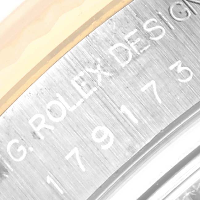 This image shows a close-up of the serial engraving on the bezel of a Rolex Datejust 179173 Women's Steel and Gold (two tone) Champagne Dial 179173 Women's Steel and Gold (two tone) Champagne Dial watch.