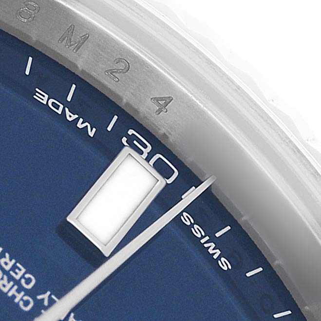 The image shows a close-up of a Rolex Datejust 116334 Men's Stainless Steel Blue Dial watch dial and bezel from a tilted angle, featuring the hour marker and second hand.