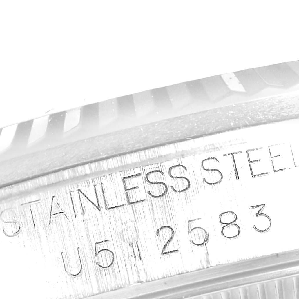 This image shows a close-up of the serial number and "STAINLESS STEEL" engraving on the bezel of a Rolex Mid-Size 28322 Women
s Stainless Steel Blue Dial 28322 Women
s Stainless Steel Blue Dial watch.