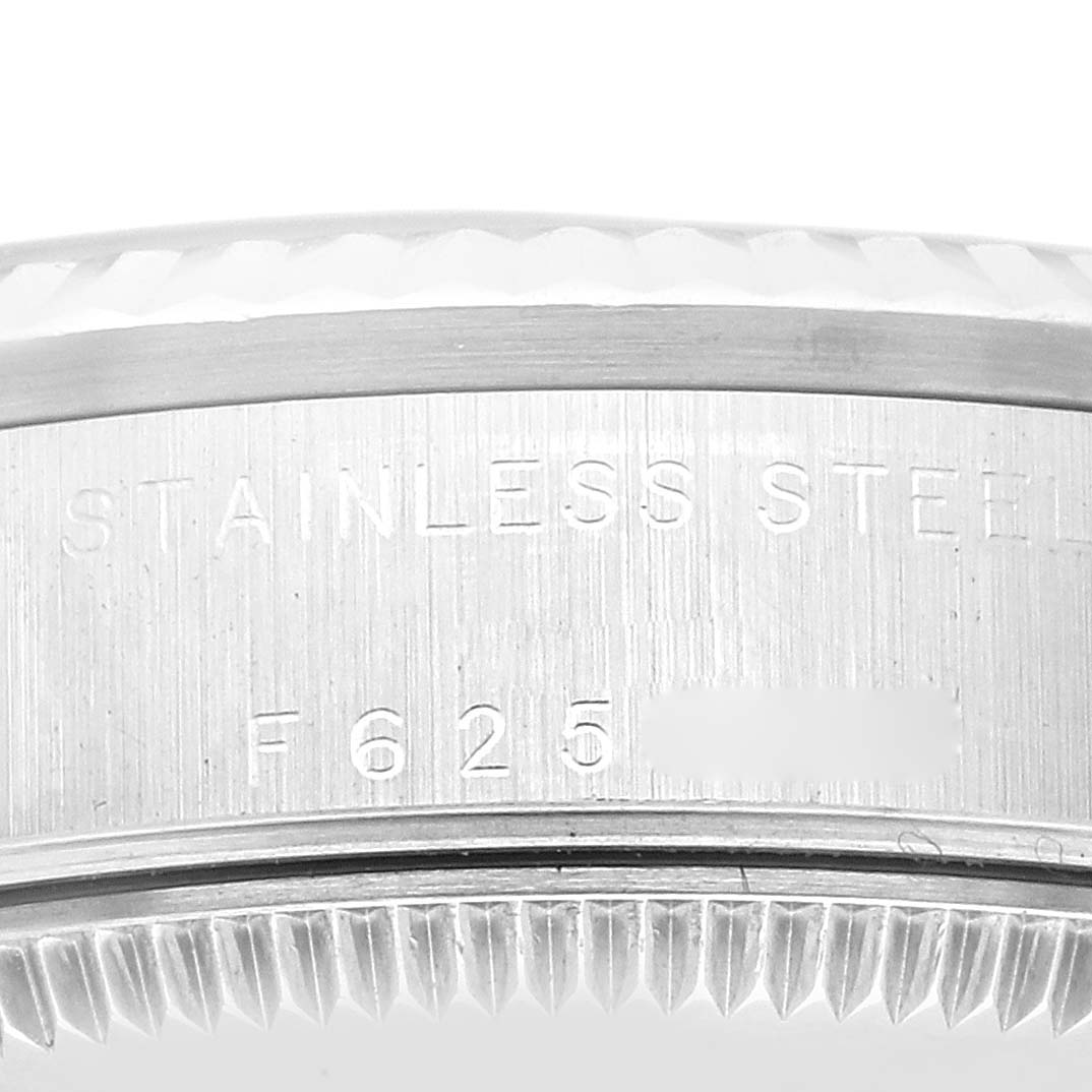 The image shows a close-up view of the stainless steel case back of a Mid-Size Rolex watch with engraved details.