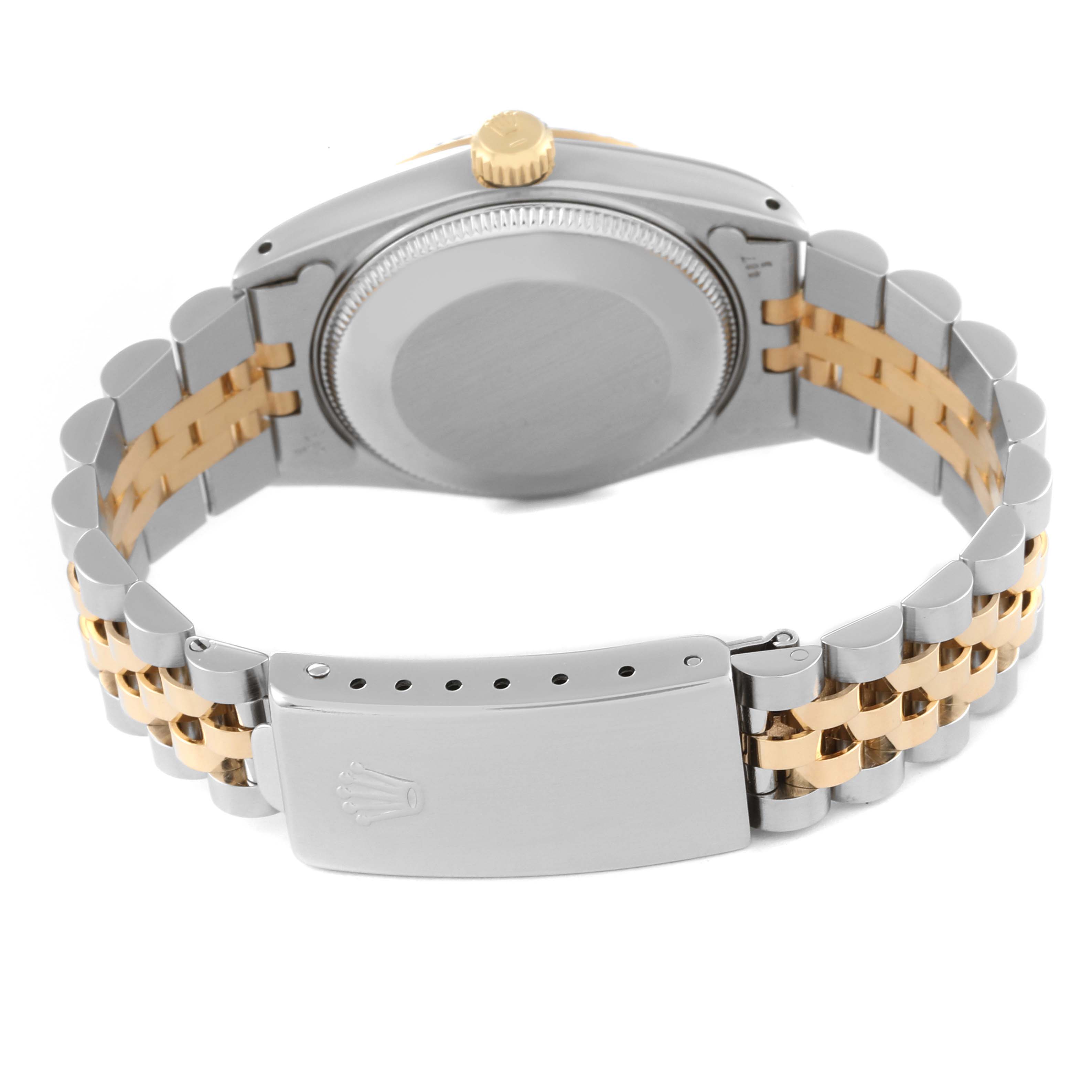 The image shows the backside and bracelet clasp of a Rolex Mid-Size 68273 Women
s Steel and Gold (two tone) Black Dial 68273 Women
s Steel and Gold (two tone) Black Dial model watch at a slightly elevated angle.