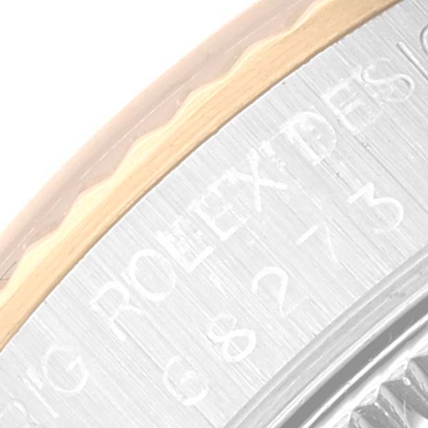This close-up image shows the detailed engraving on the bezel and case of a Rolex Mid-Size 68273 Women
s Steel and Gold (two tone) Black Dial 68273 Women
s Steel and Gold (two tone) Black Dial model watch.
