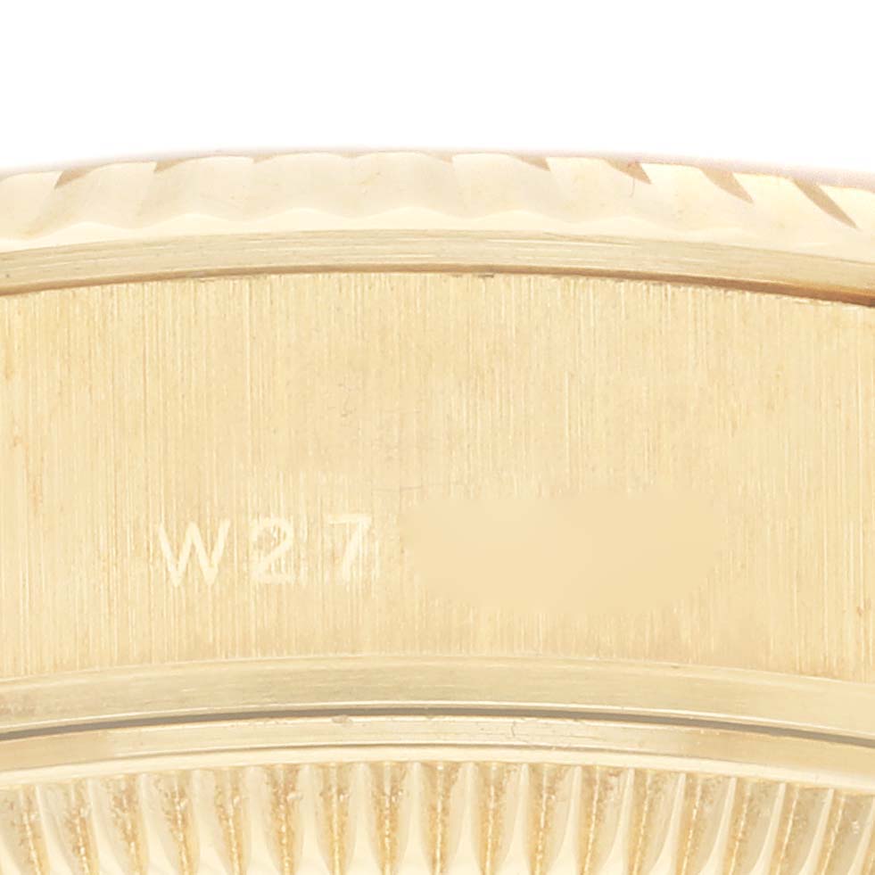 The image shows a close-up of the side of the Rolex President 69178 Women's Yellow Gold Champagne Dial 69178 Women's Yellow Gold Champagne Dial model watch case, featuring engraved markings.