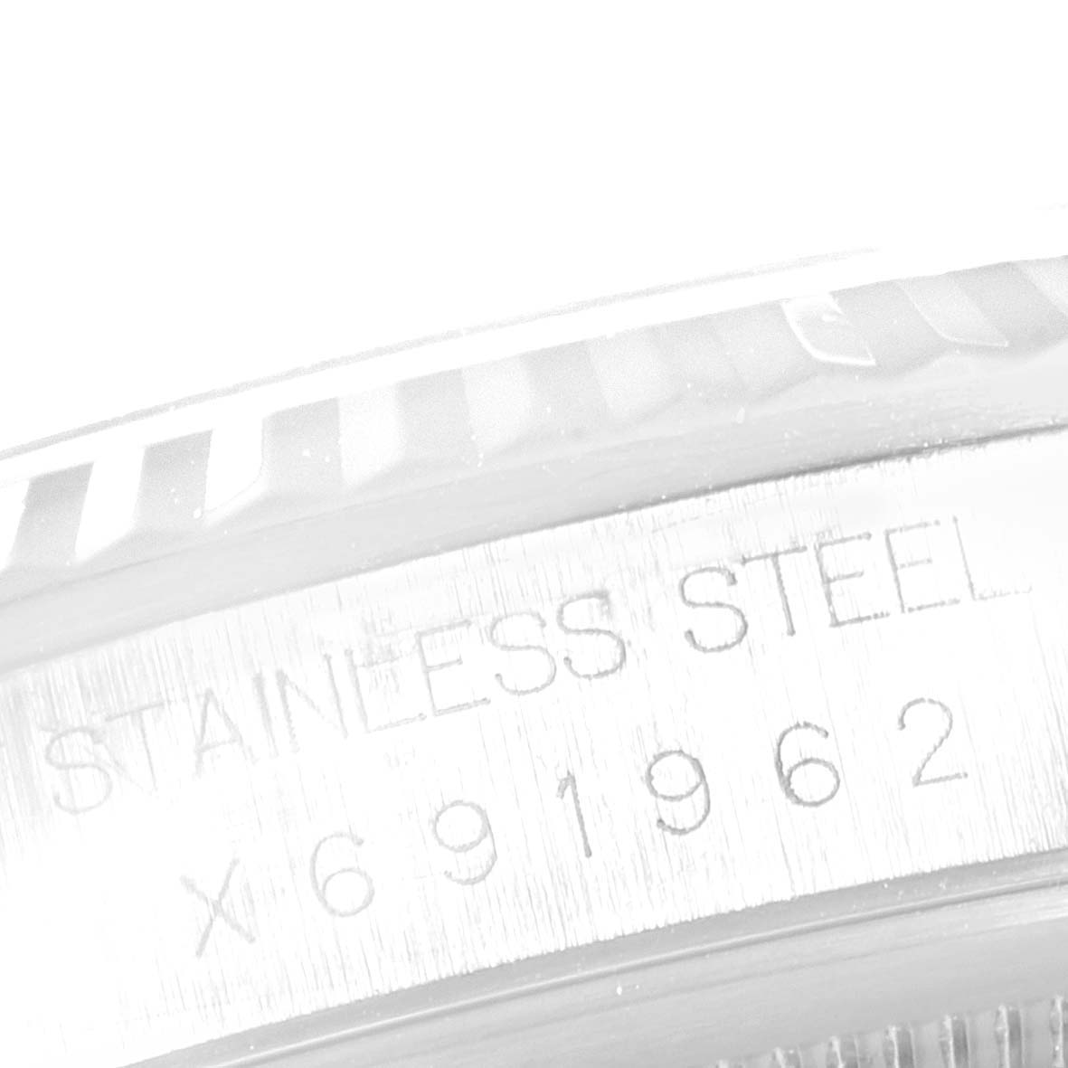 The image shows a close-up of the case's engraved serial number and stainless steel branding on a Rolex Datejust 16234 Men's Stainless Steel Silver Dial 16234 Men's Stainless Steel Silver Dial watch.