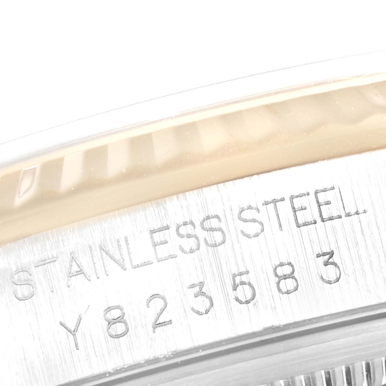 This close-up image shows the serial number and "STAINLESS STEEL" engraving on the case back of a Rolex Datejust 16233 Men
s Steel and Gold (two tone) Champagne Dial 16233 Men
s Steel and Gold (two tone) Champagne Dial watch.