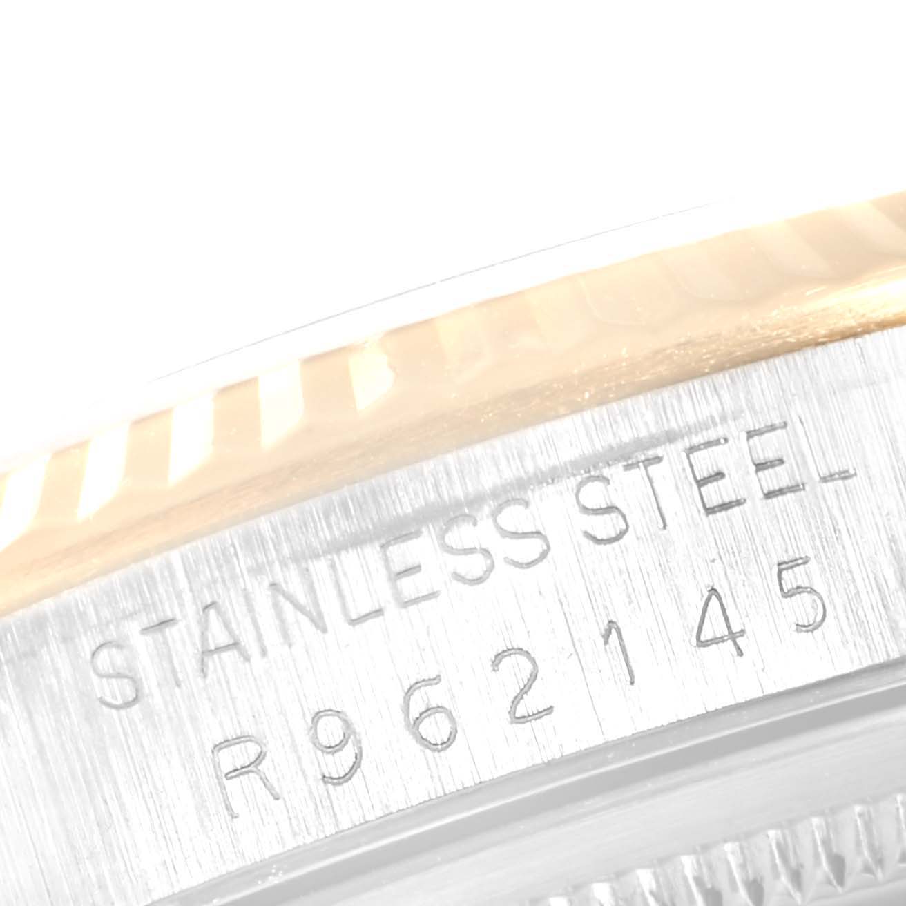 This close-up shows the engraved serial number on the stainless steel case of a Rolex Datejust 16233 Men's Stainless Steel Champagne Dial 16233 Men's Stainless Steel Champagne Dial watch.