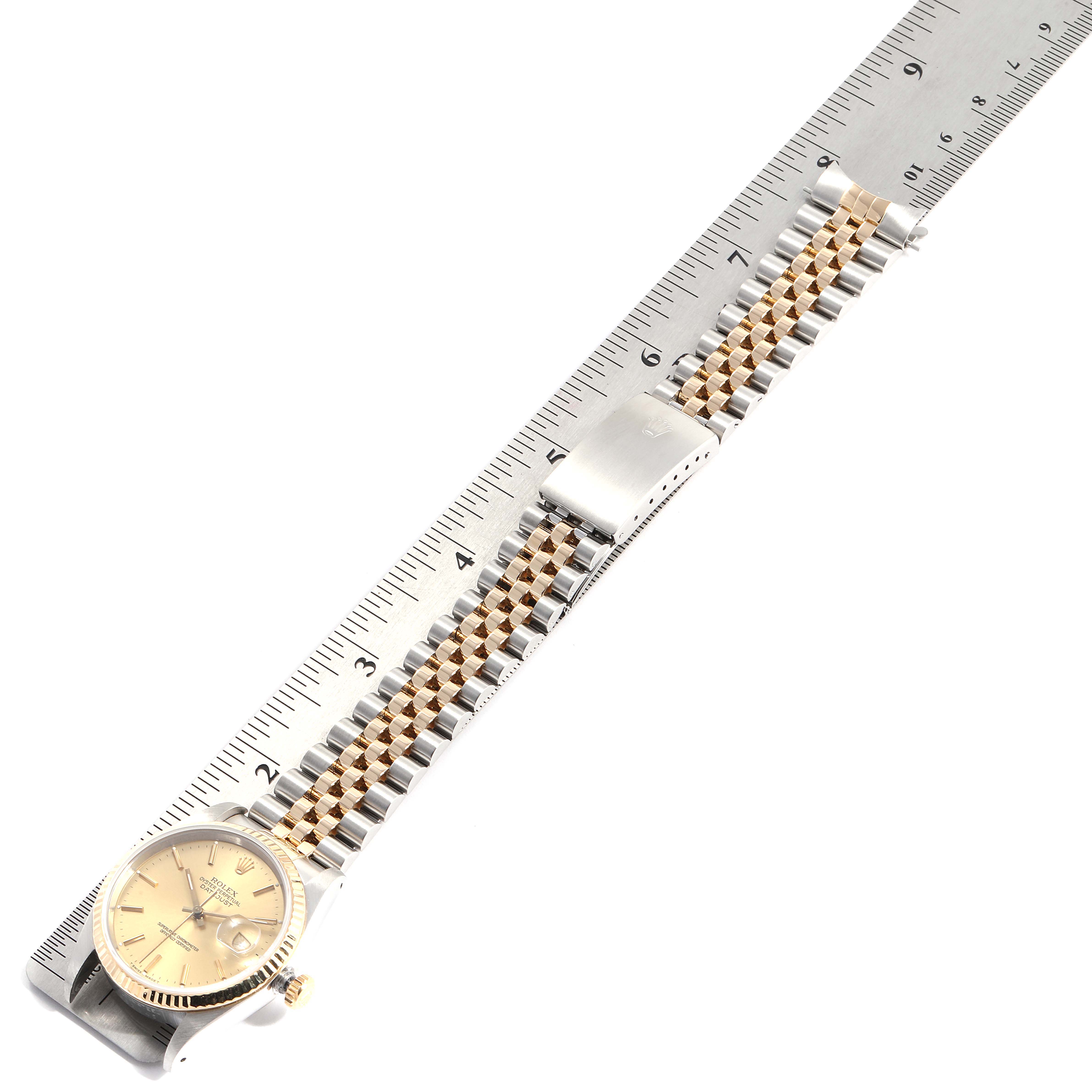 The image shows a Rolex Datejust 16233 Men's Stainless Steel Champagne Dial 16233 Men's Stainless Steel Champagne Dial watch laid flat with its bracelet and clasp extended alongside a ruler for measurement.