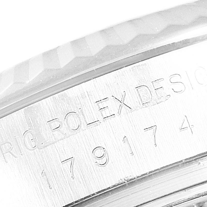 The image shows a close-up of the engraved Rolex Datejust 179174 Women's Stainless Steel Mother of Pearl Dial 179174 Women's Stainless Steel Mother of Pearl Dial model number and part of the fluted bezel.