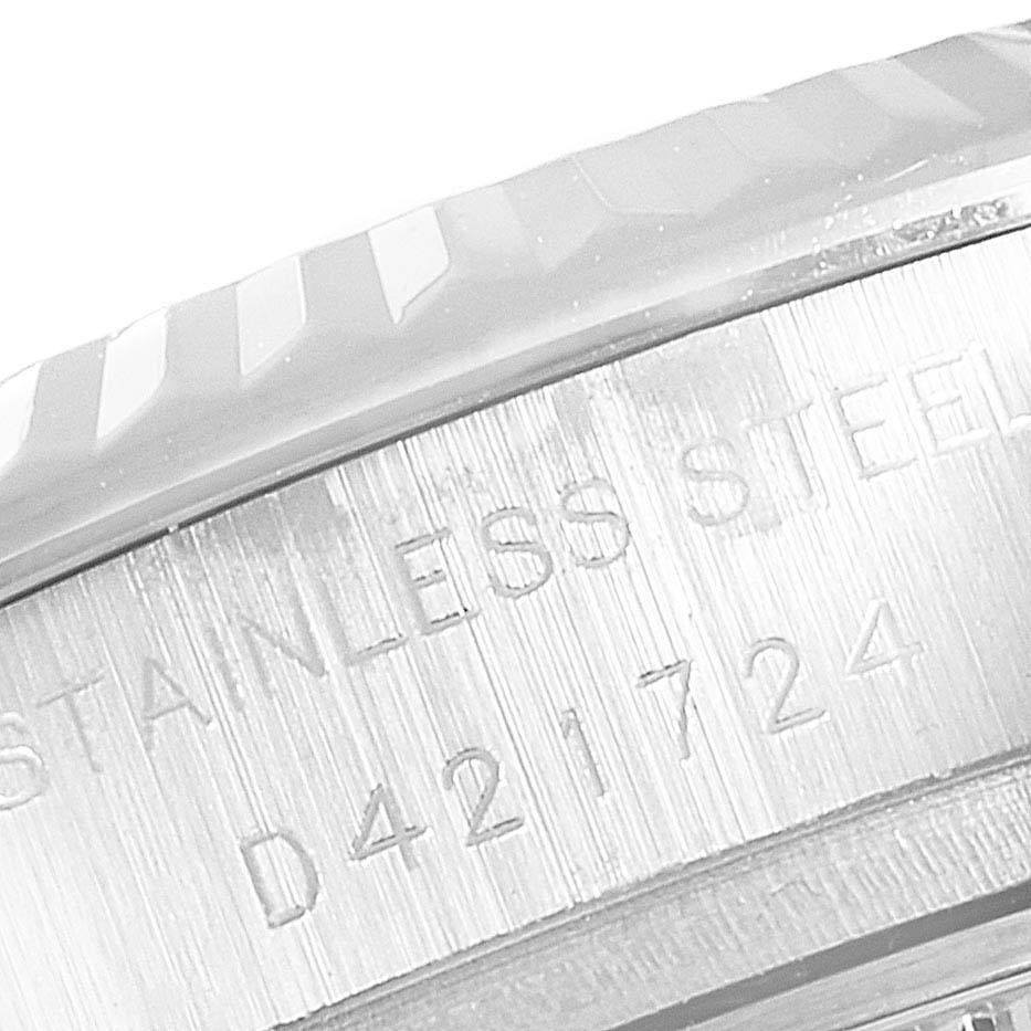 The image shows a close-up of the side of the bezel and case of a Rolex Datejust 179174 Women's Stainless Steel Mother of Pearl Dial 179174 Women's Stainless Steel Mother of Pearl Dial, revealing its stainless steel material and serial number.