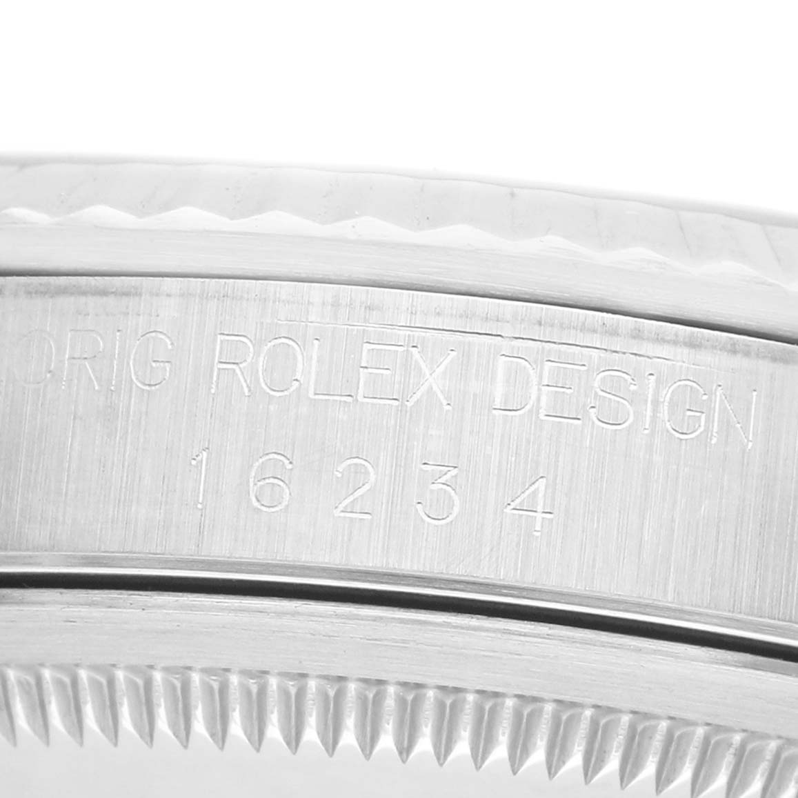 The image shows a close-up of the serial number engraving on the side of a Rolex Datejust 16234 Men's Stainless Steel Silver Dial case.