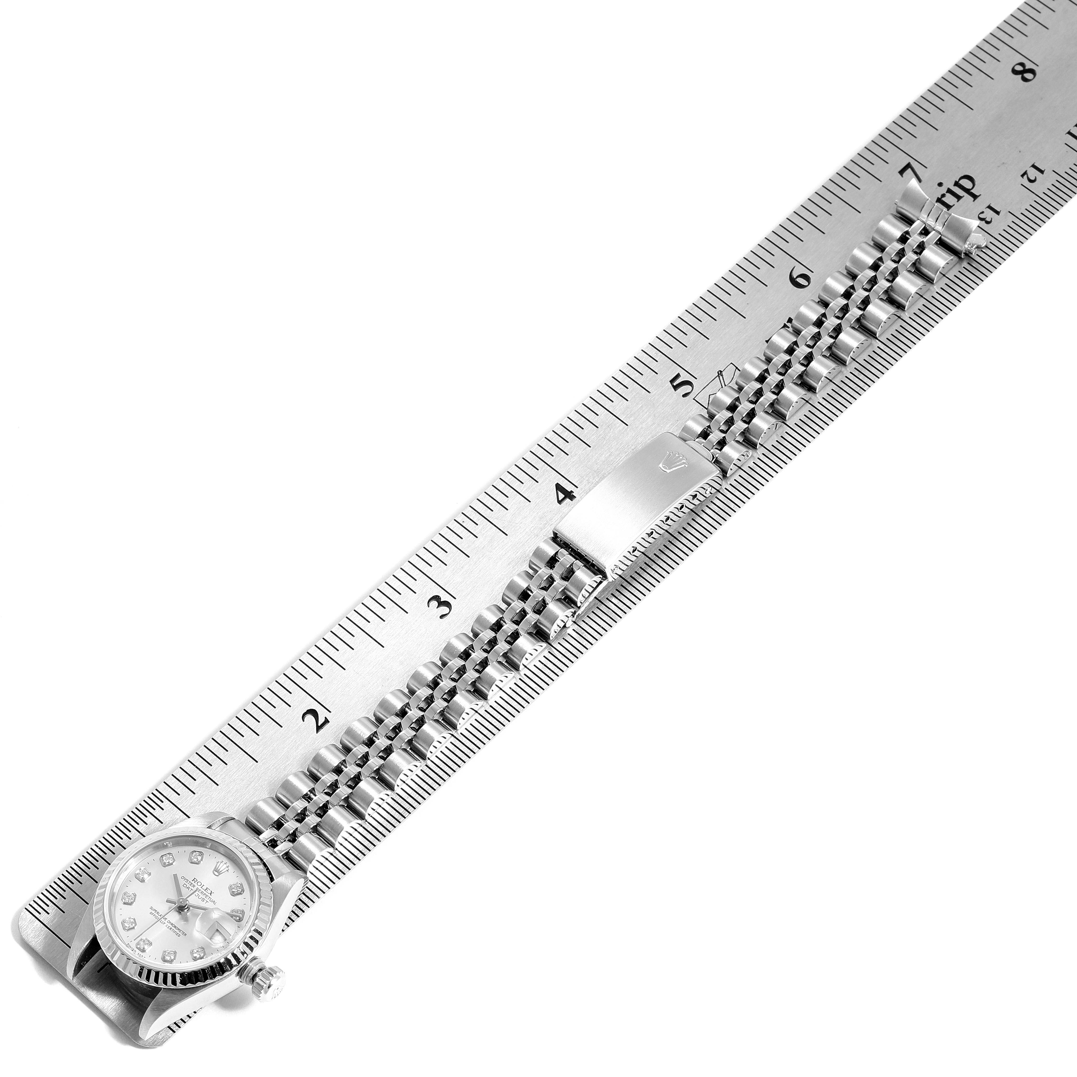 The watch shown is a Rolex Datejust 69174 Women
s Stainless Steel Silver Dial 69174 Women
s Stainless Steel Silver Dial model, displayed horizontally with its bracelet and part of the case visible, alongside a ruler for measurement.