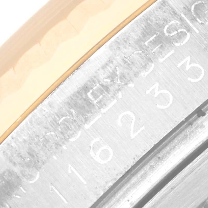 Close-up of the serial number and bezel of the Rolex Datejust 116233 Men's Steel and Gold (two tone) Champagne Dial 116233 Men's Steel and Gold (two tone) Champagne Dial watch, focusing on the engravings.