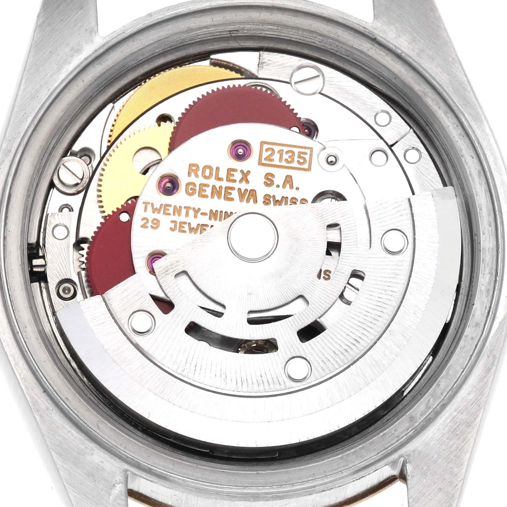 This image shows the movement of a Rolex Datejust 69173 Women
s Steel and Gold (two tone) Black Dial 69173 Women
s Steel and Gold (two tone) Black Dial watch from a top-down angle, revealing gears and inscriptions.