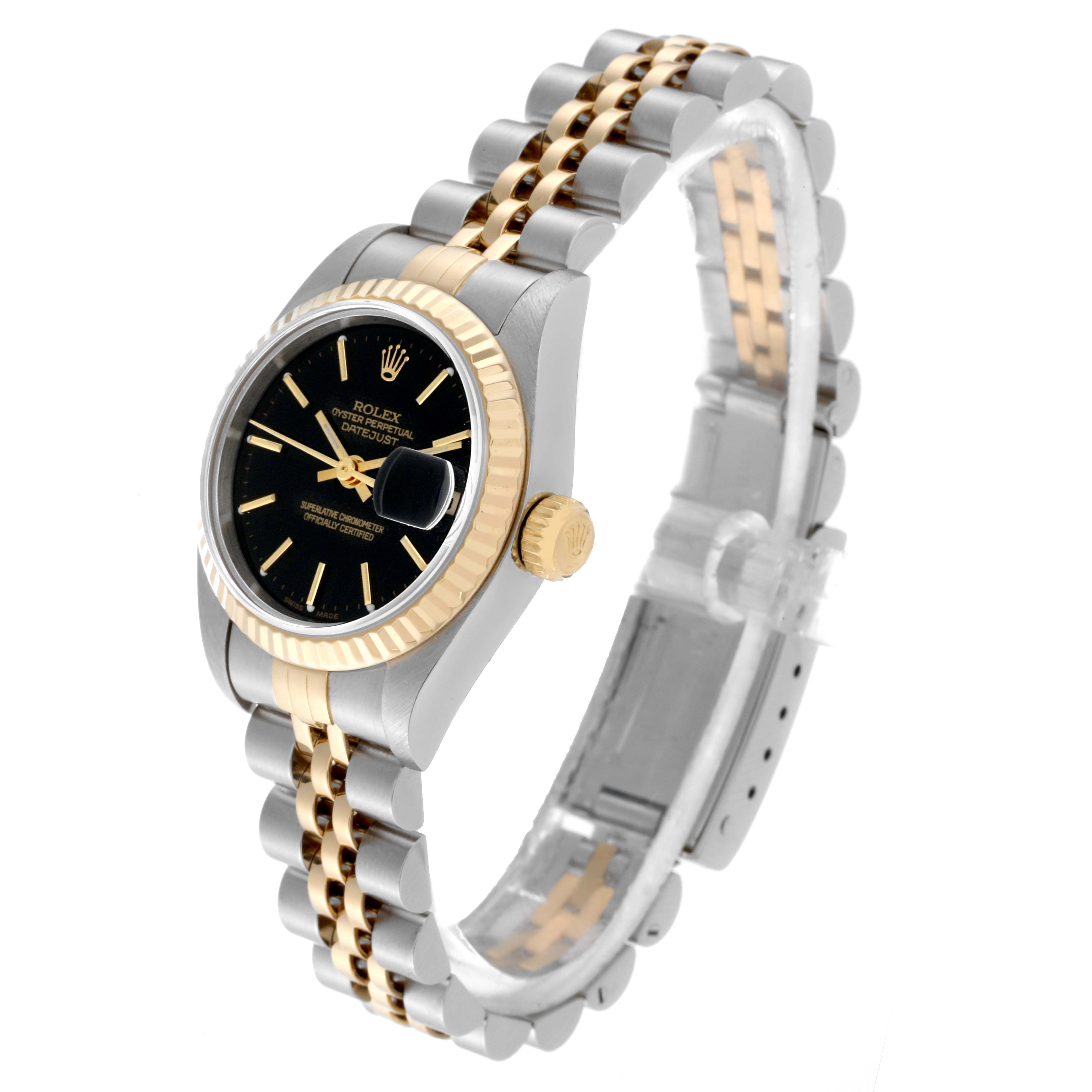 The image shows a Rolex Datejust 79173 Women's Steel and Gold (two tone) Black Dial 79173 Women's Steel and Gold (two tone) Black Dial watch at an angled side view, displaying the black dial face, gold fluted bezel, and two-tone bracelet.