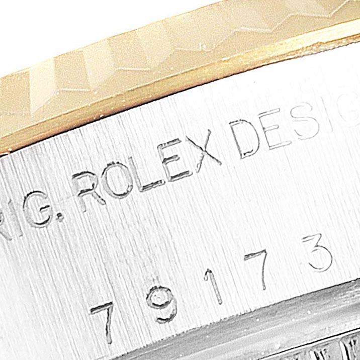 This close-up angle shows part of the case and the engraved serial number of the Rolex Datejust 79173 Women
s Steel and Gold (two tone) Champagne Dial 79173 Women
s Steel and Gold (two tone) Champagne Dial model.