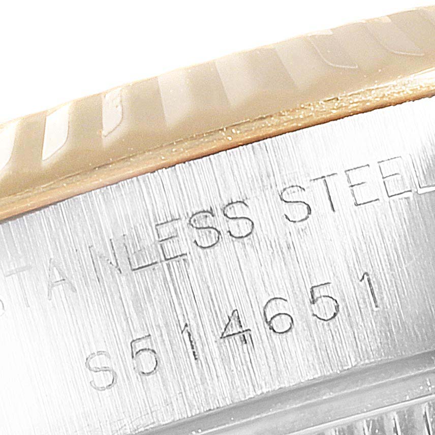 The image shows a close-up of the Rolex Datejust 69173 Women's Steel and Gold (two tone) Red Dial 69173 Women's Steel and Gold (two tone) Red Dial's stainless steel casing with part of the model number engraved.