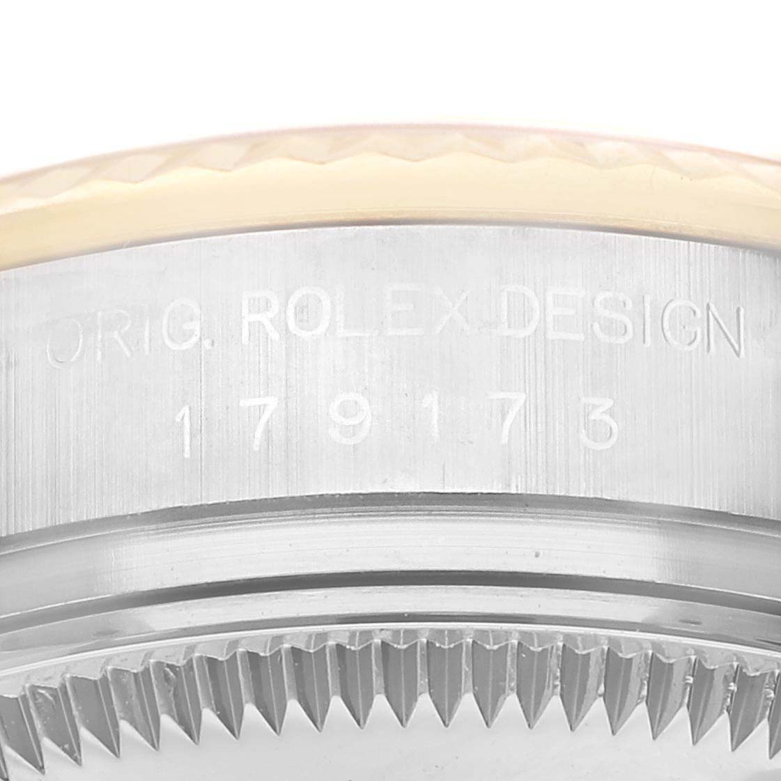 The image shows a close-up of the serial number and the edge of the bezel of a Rolex Datejust 179173 Women's Steel and Gold (two tone) White Dial 179173 Women's Steel and Gold (two tone) White Dial watch.
