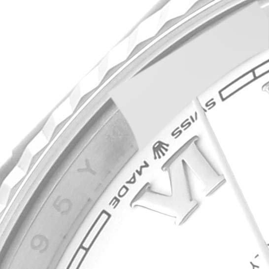 This image shows a close-up angle of the dial and a portion of the fluted bezel of a Rolex President 128239 Men's White Gold White Dial 128239 Men's White Gold White Dial model watch.