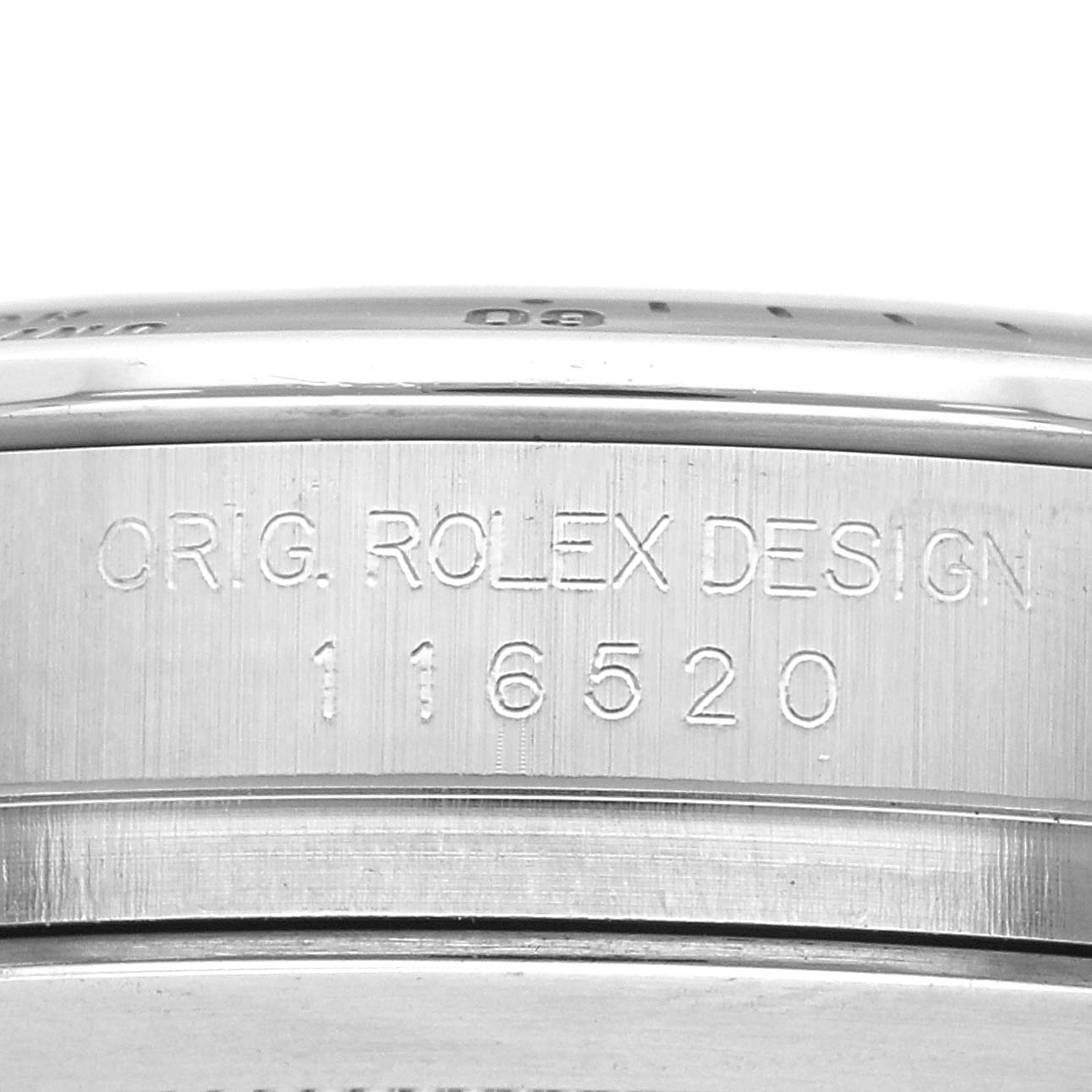 The image shows the side engraving on the case of a Rolex Daytona 116520 Men's Stainless Steel Black Dial 116520 Men's Stainless Steel Black Dial, displaying model number "116520" and "ORIG. ROLEX DESIGN."