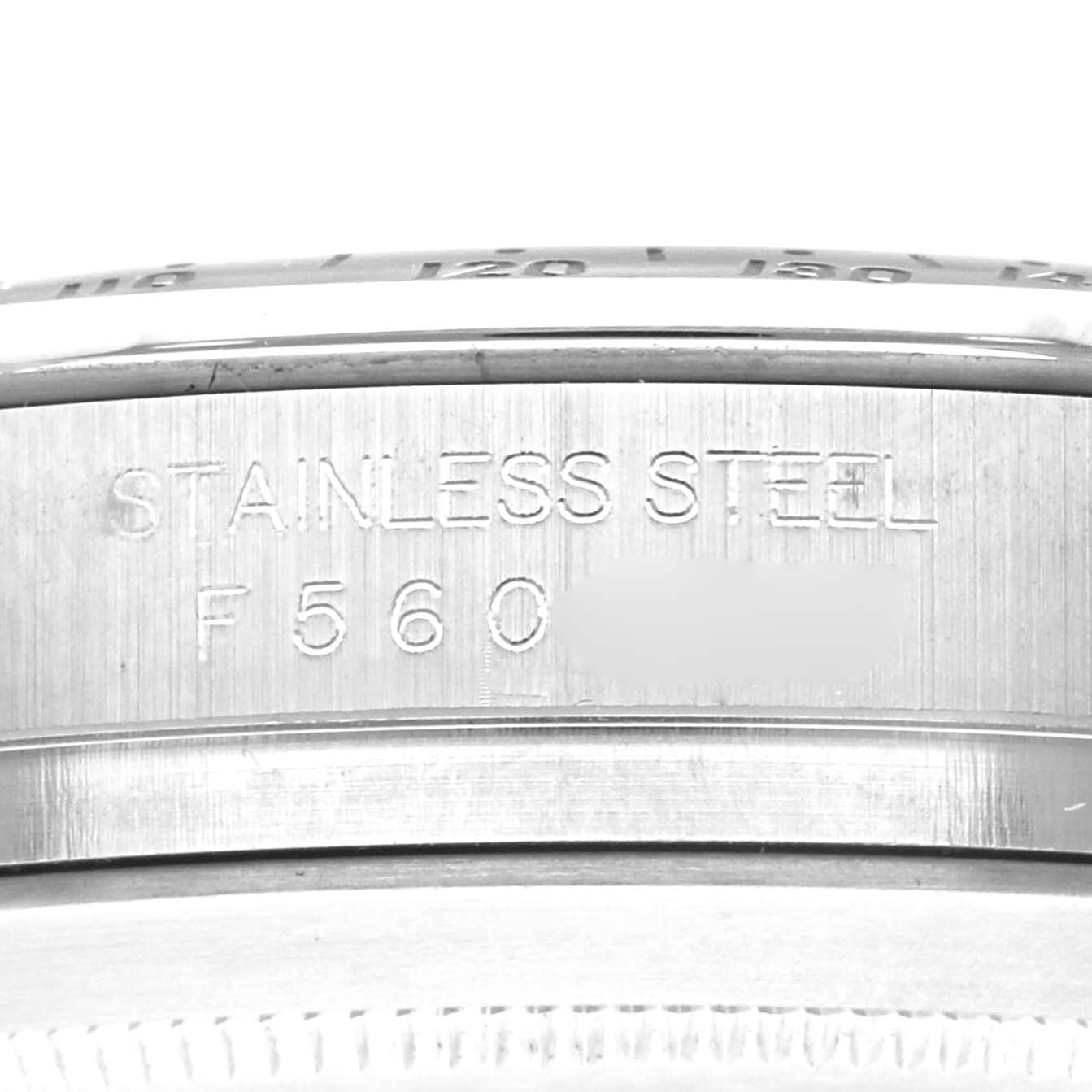 The image shows a close-up of the side of a Rolex Daytona 116520 Men's Stainless Steel Black Dial 116520 Men's Stainless Steel Black Dial, focusing on the stainless steel case and engravings.