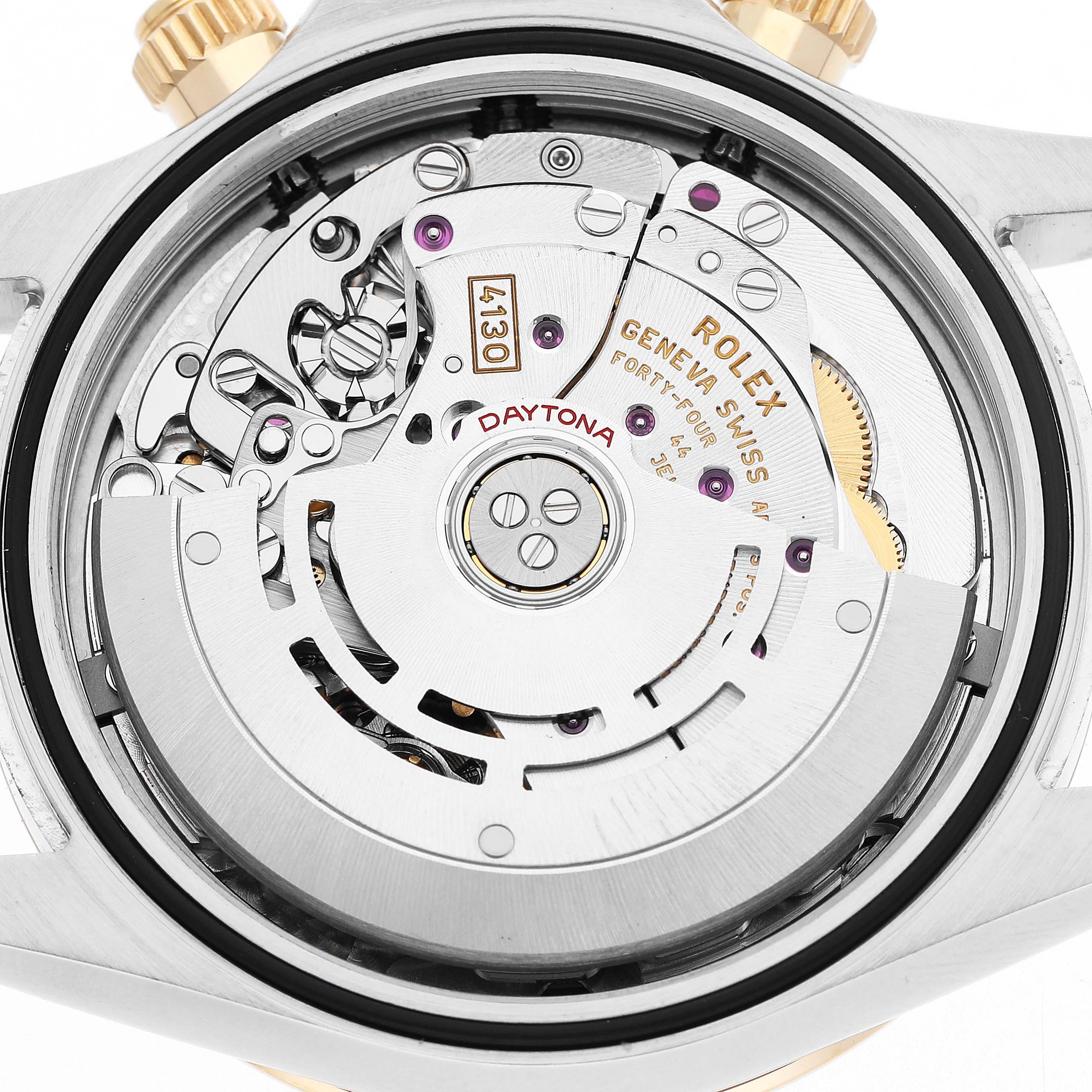 The image shows the movement of a Rolex Daytona 116503 Men's Steel and Gold (two tone) White Dial watch from the back, highlighting gears and the rotor.