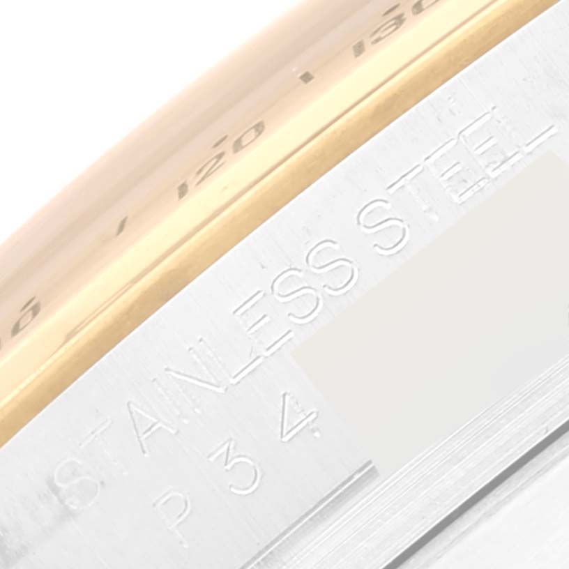 The image shows a close-up of the side of a Rolex Daytona 116523 Men
s Steel and Gold (two tone) White Dial 116523 Men
s Steel and Gold (two tone) White Dial watch, highlighting the stainless steel marking.