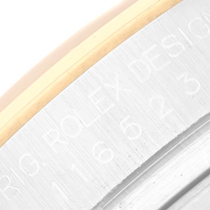 This image shows a close-up of the engraved case side of a Rolex Daytona 116523 Men
s Steel and Gold (two tone) White Dial 116523 Men
s Steel and Gold (two tone) White Dial watch.